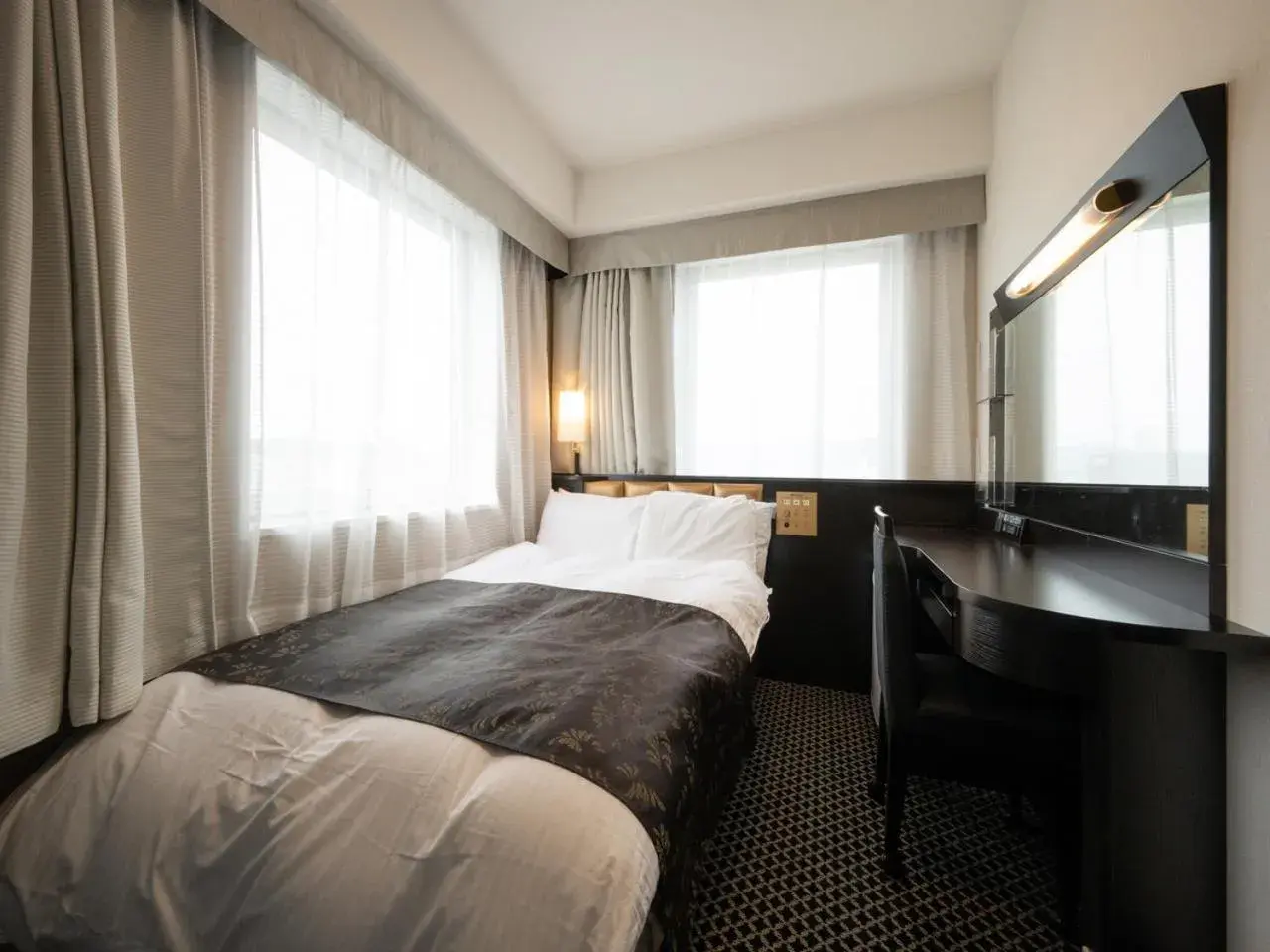 Bed in APA Hotel Fukui Katamachi Bed in APA Hotel Fukui Katamachi