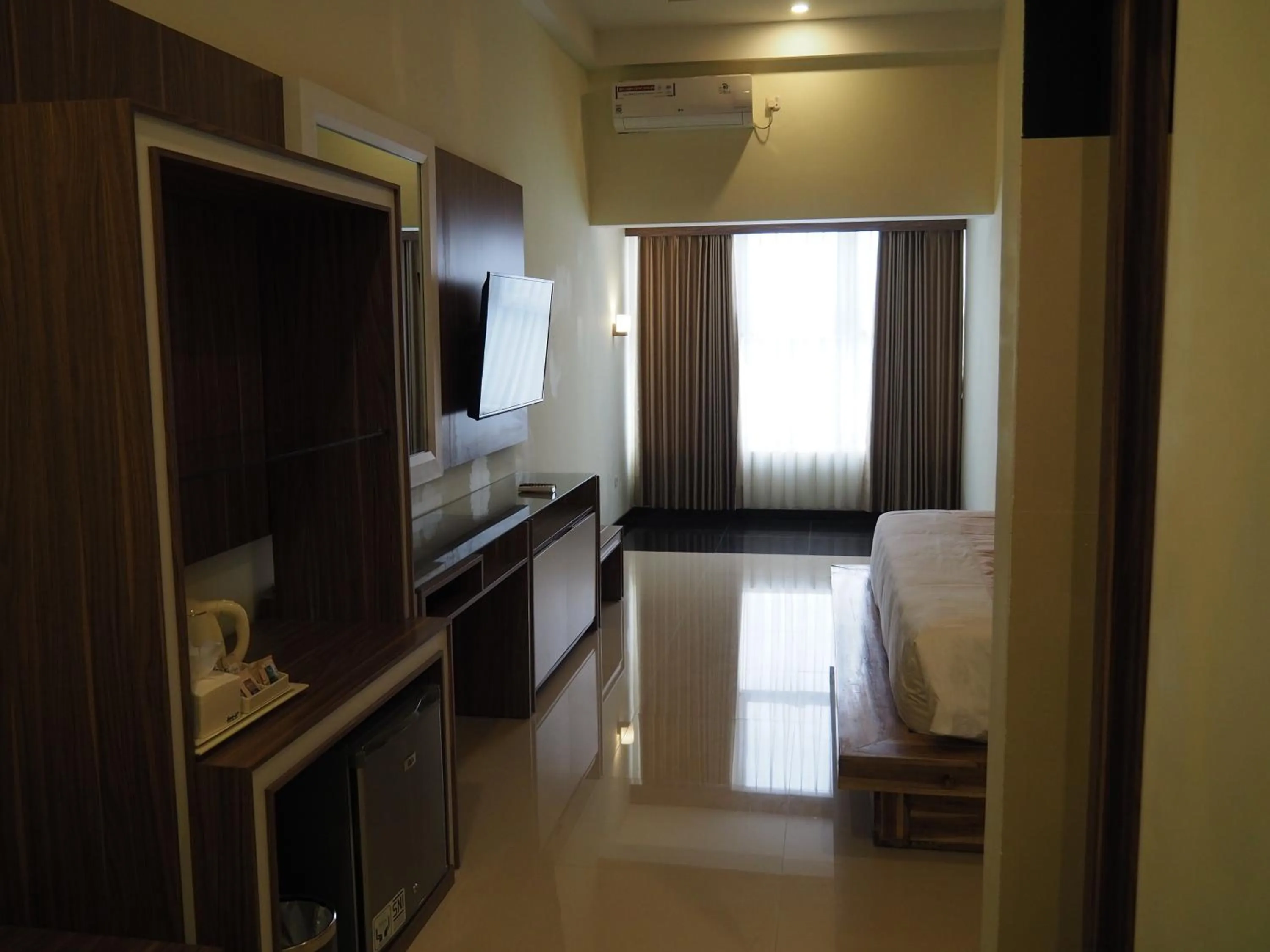 Communal lounge/ TV room, Bed in Luminor Hotel Banyuwangi By WH