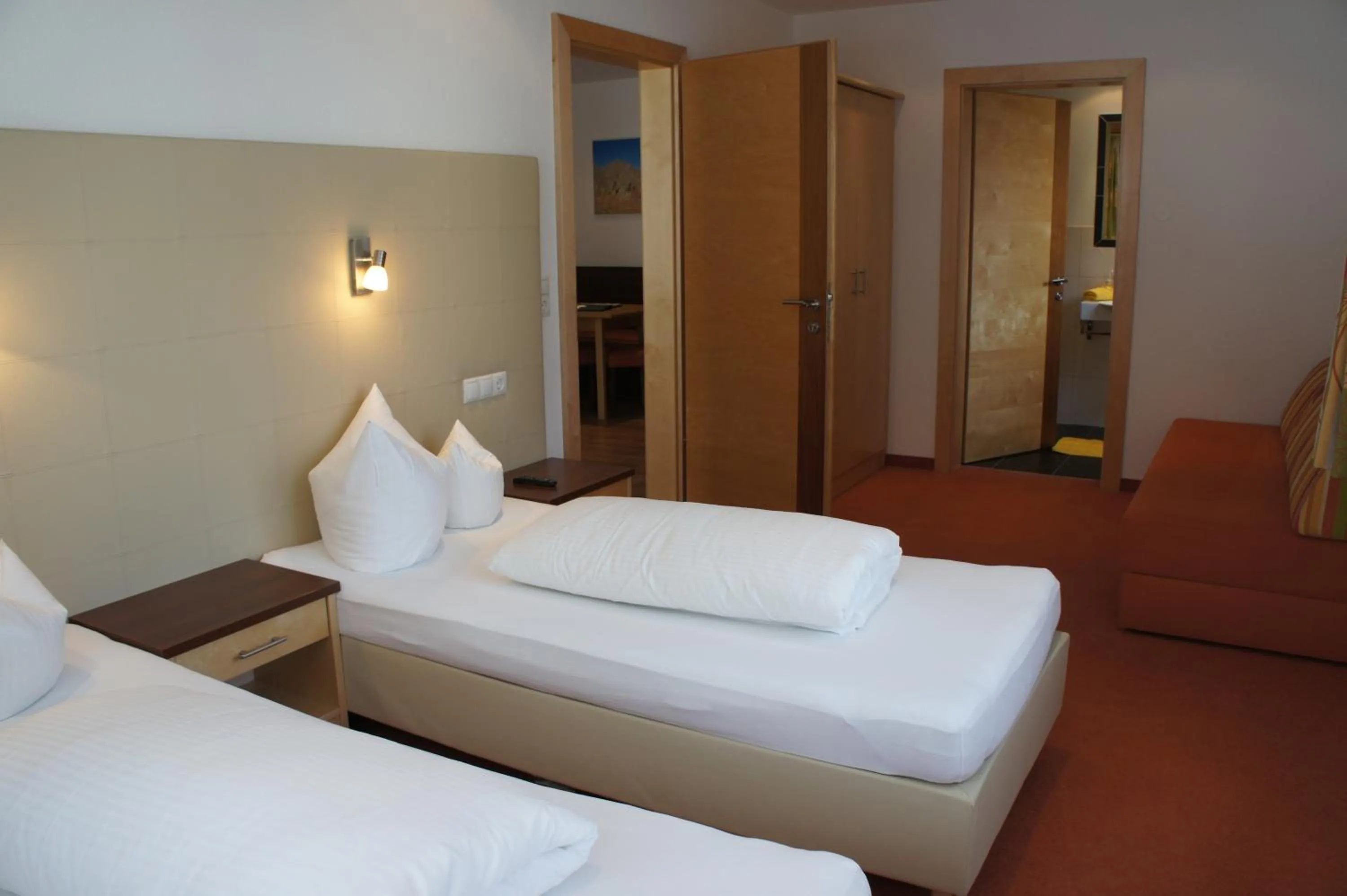 Bathroom, Bed in alpinea Appartements