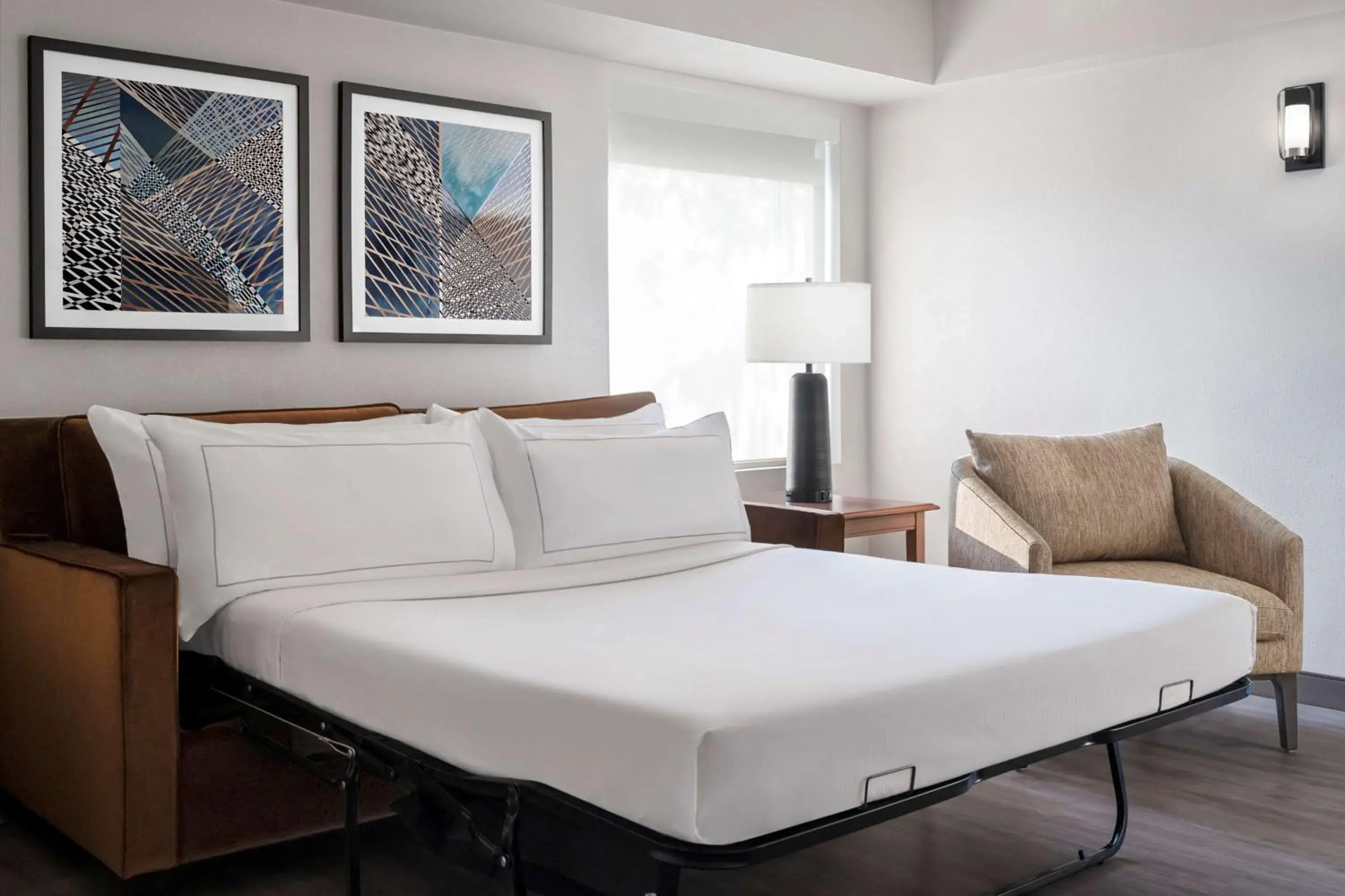 Living room, Bed in The Alloy, a DoubleTree by Hilton - Valley Forge Living room, Bed in The Alloy, a DoubleTree by Hilton - Valley Forge