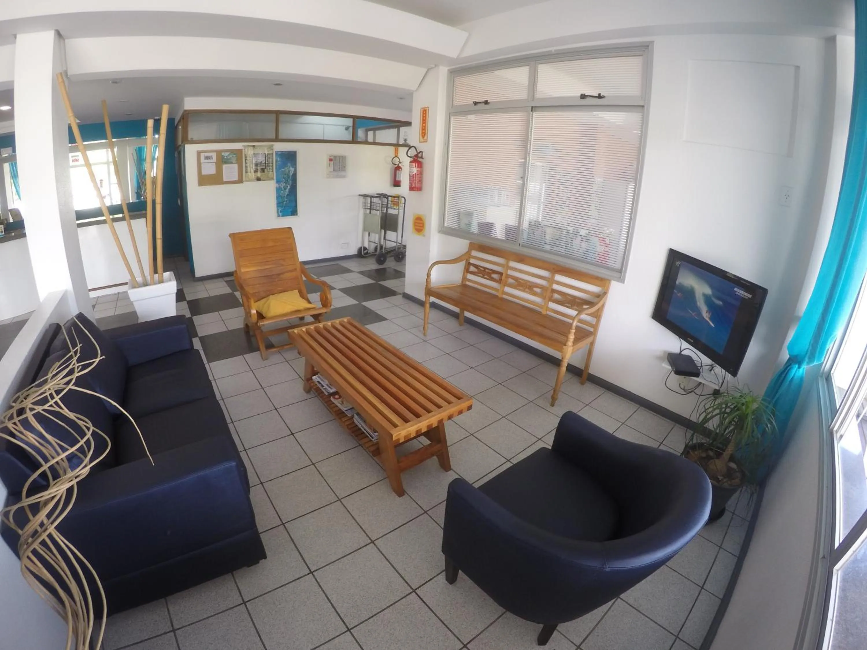 Communal lounge/ TV room in Joaquina Beach Hotel