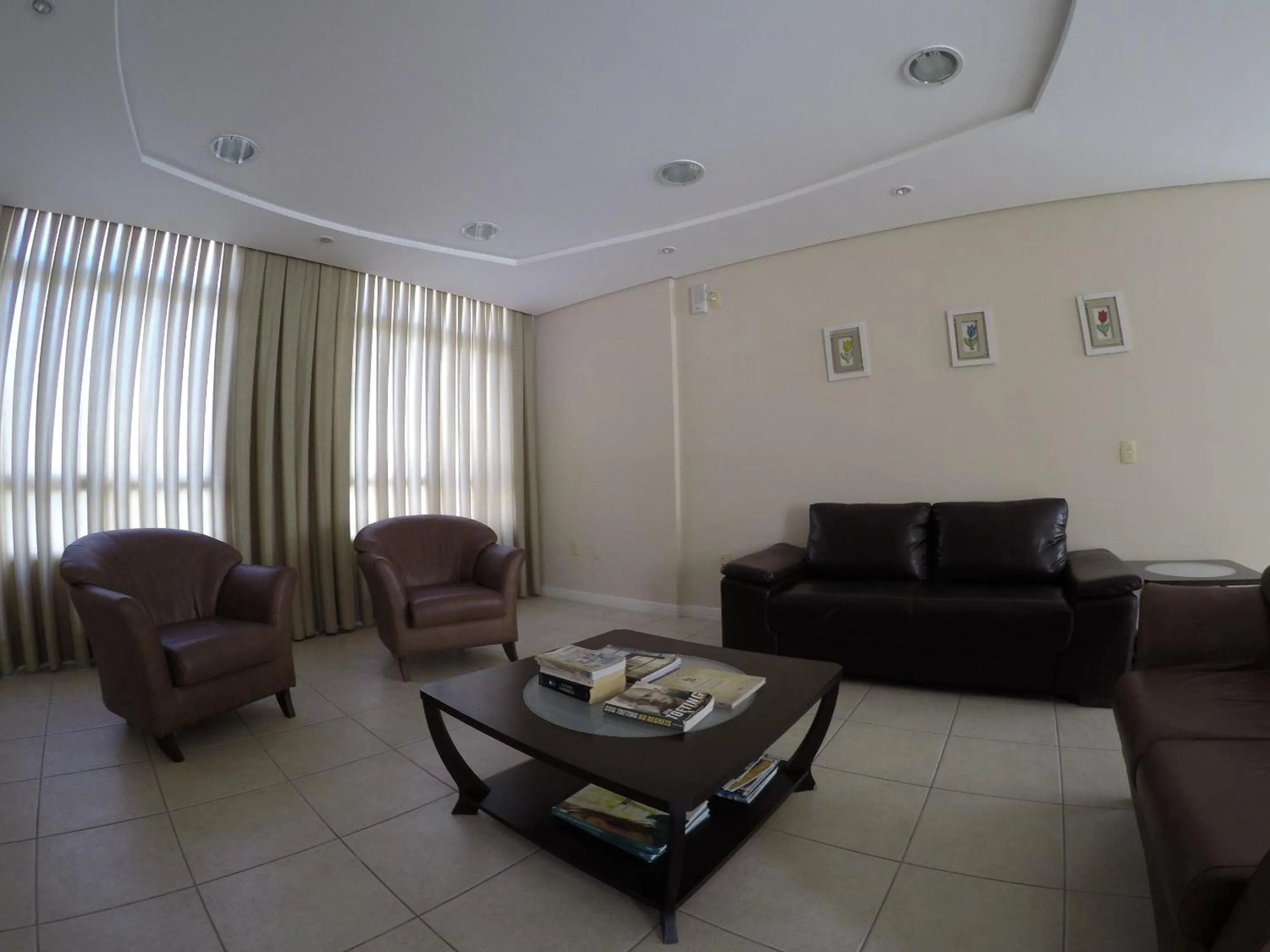 Communal lounge/ TV room in Joaquina Beach Hotel