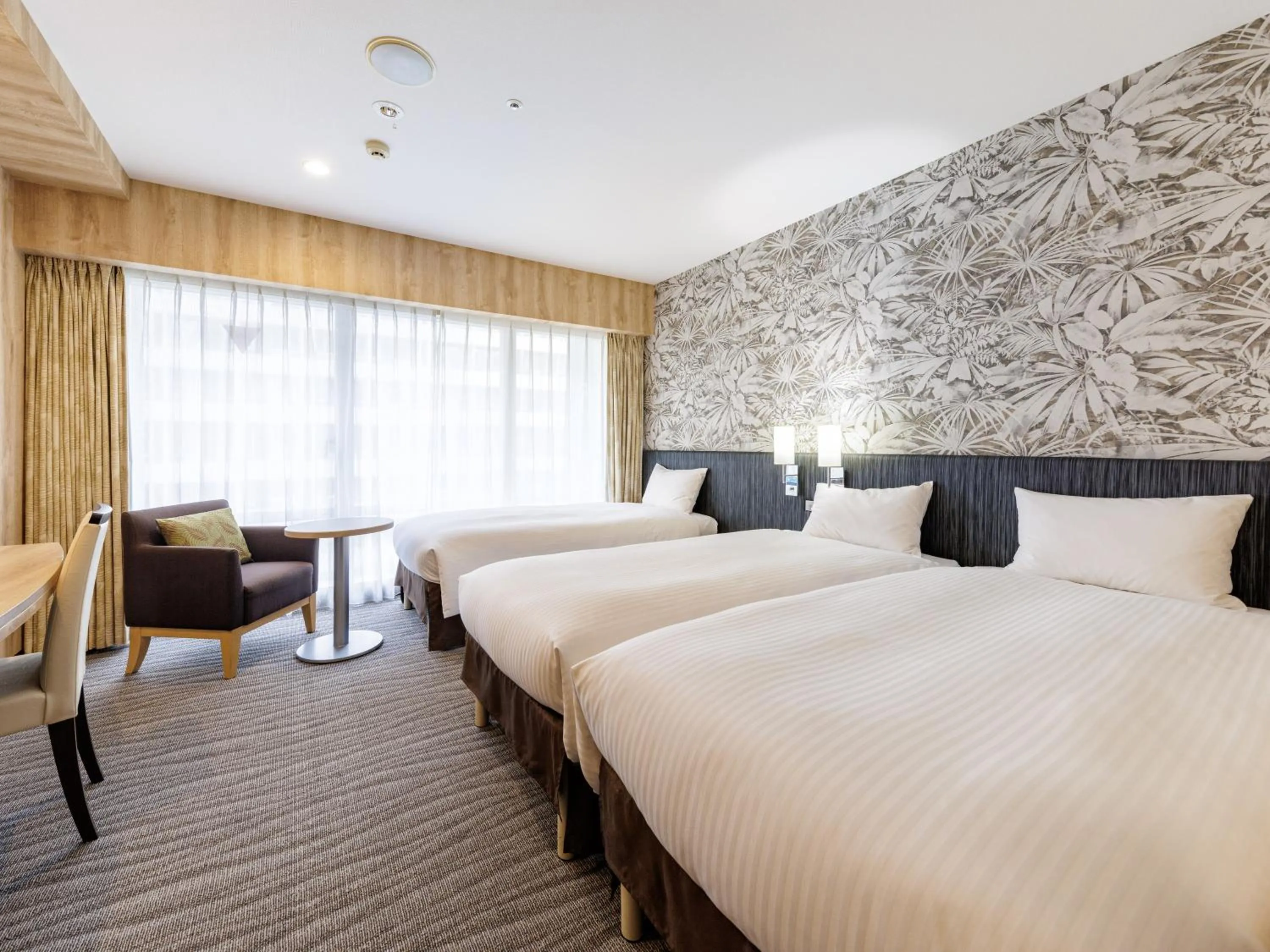 Bed in Nishitetsu Resort Inn Naha