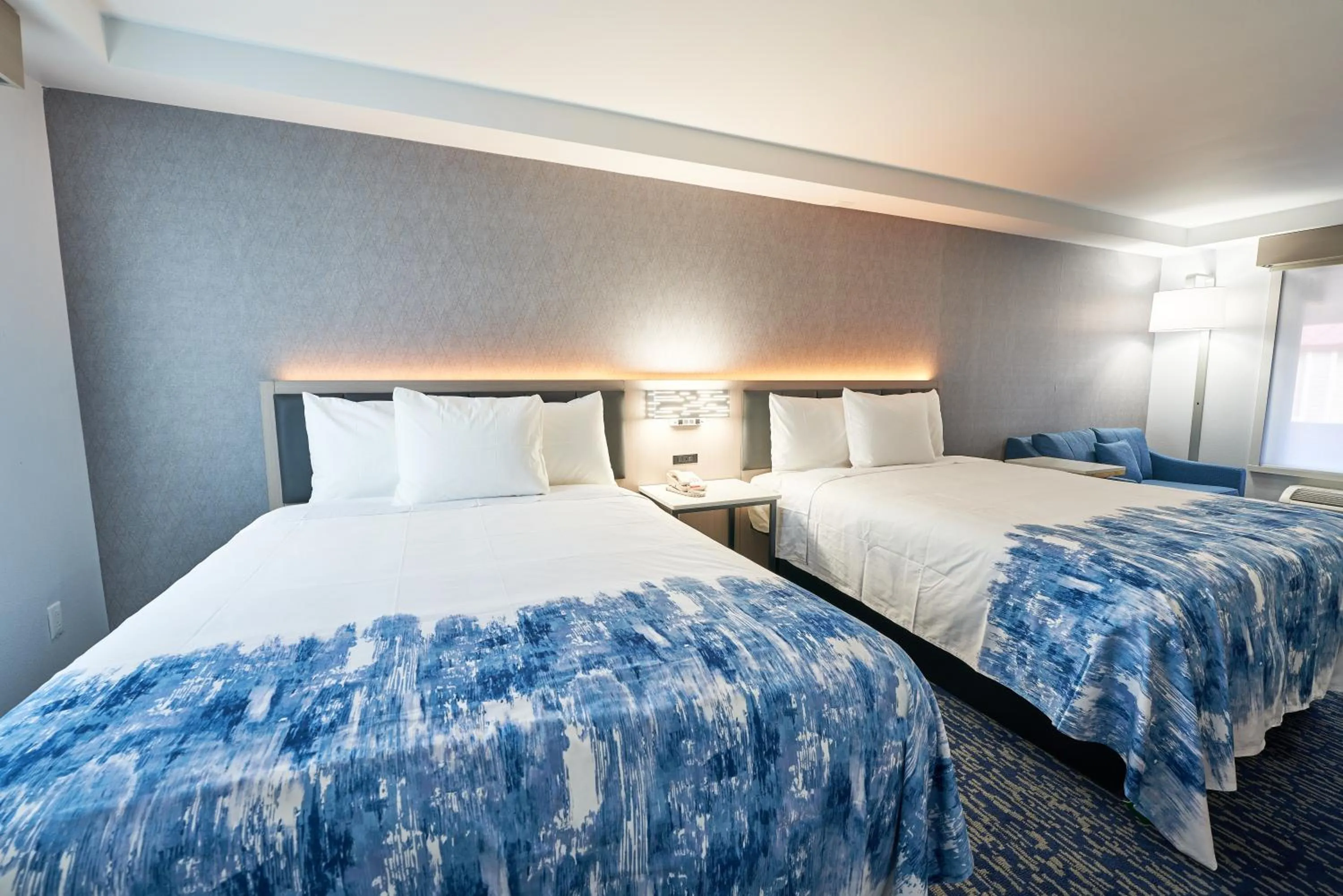 Bed in All Seasons Inn & Suites