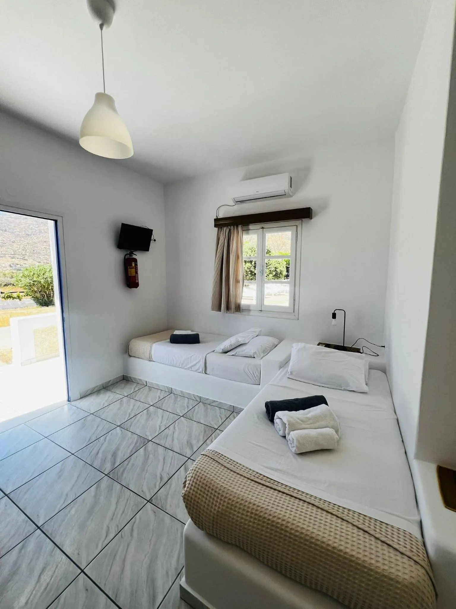 Bed in Paradise Apartments Studios