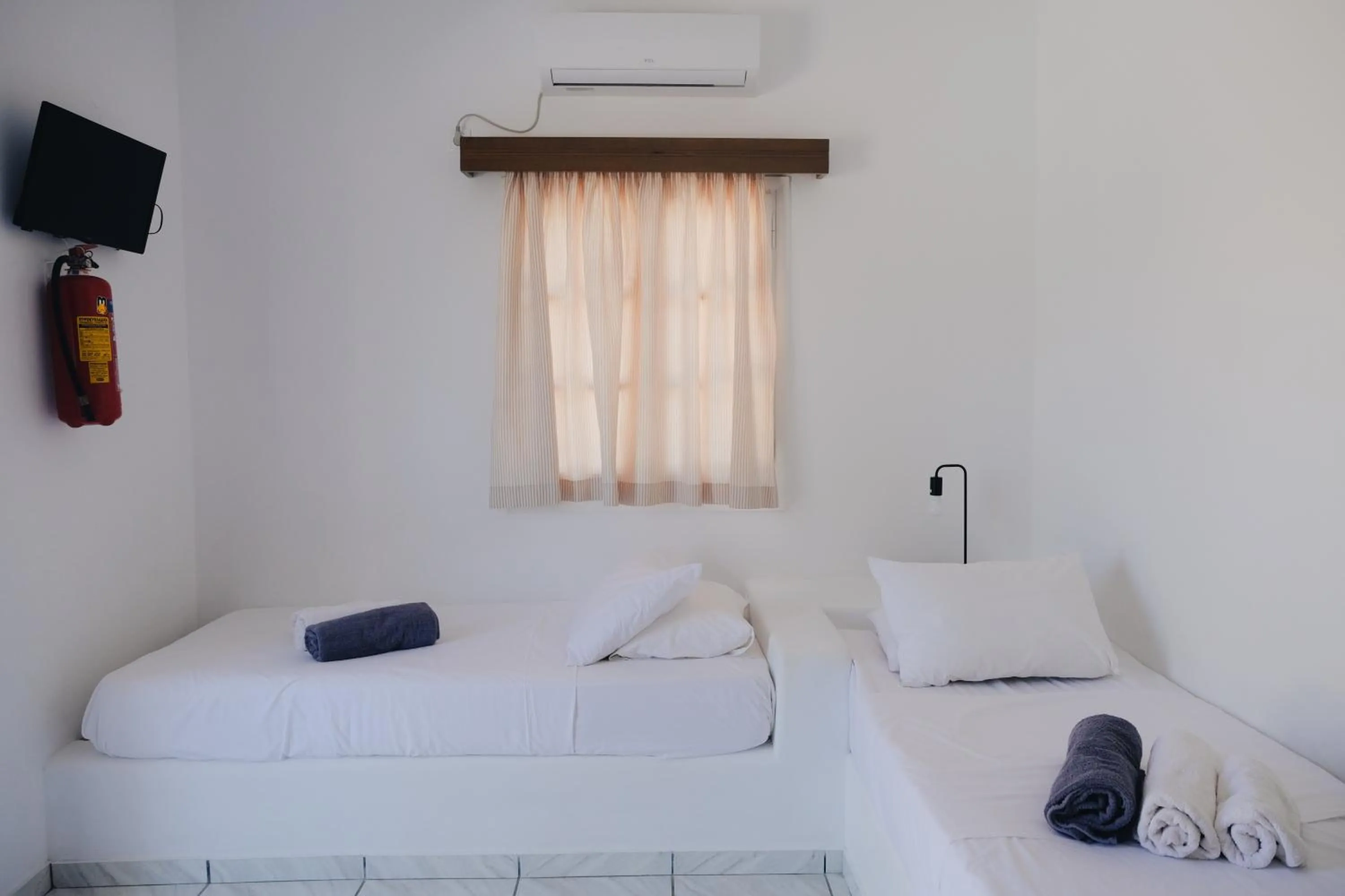 Bed in Paradise Apartments Studios