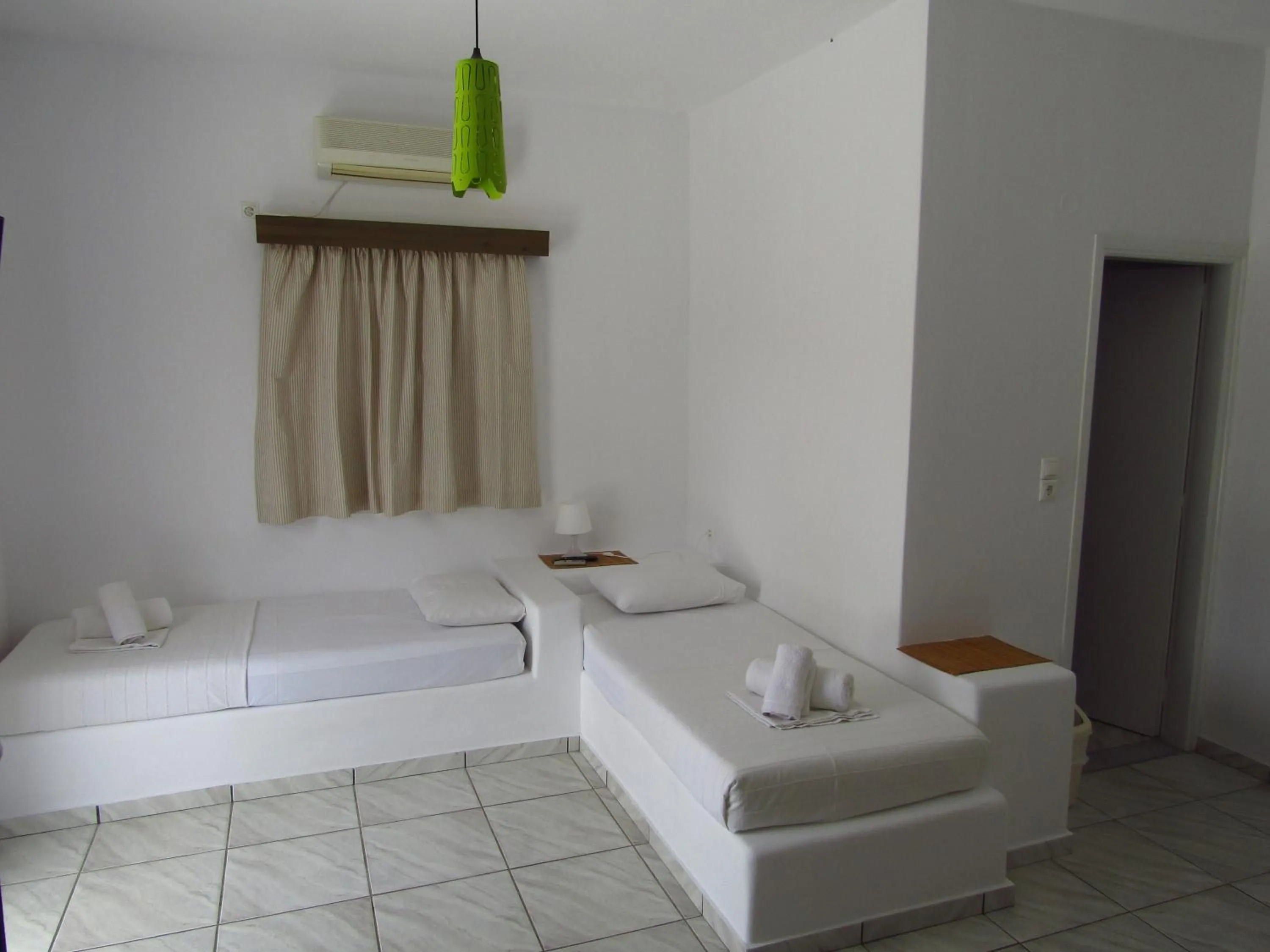 Bed in Paradise Apartments Studios