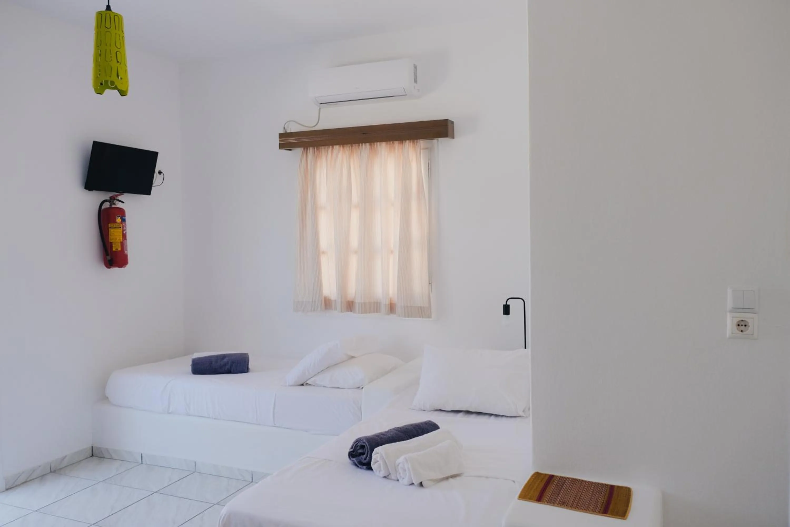 Bed in Paradise Apartments Studios