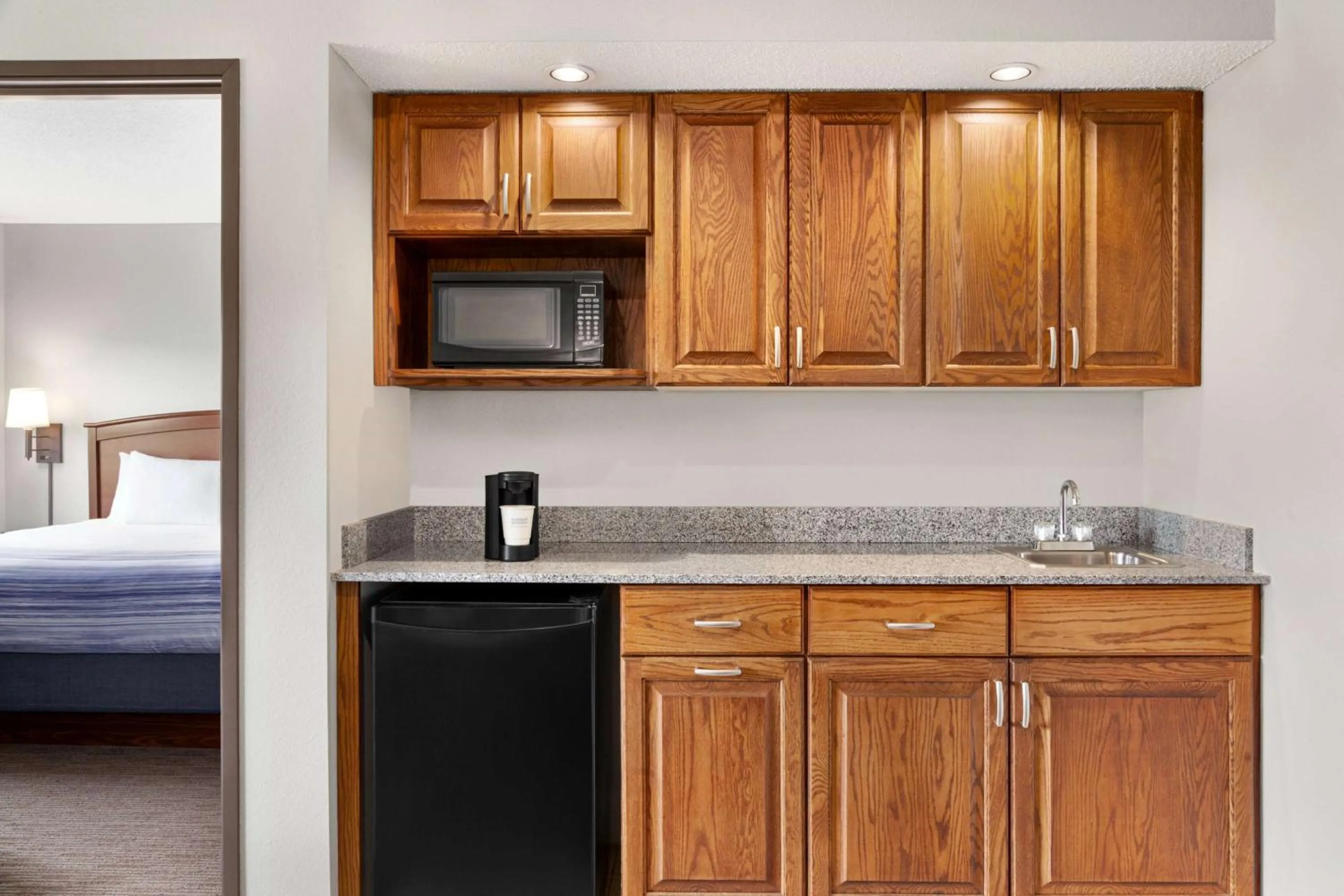 Bed in AmericInn by Wyndham Sauk Centre