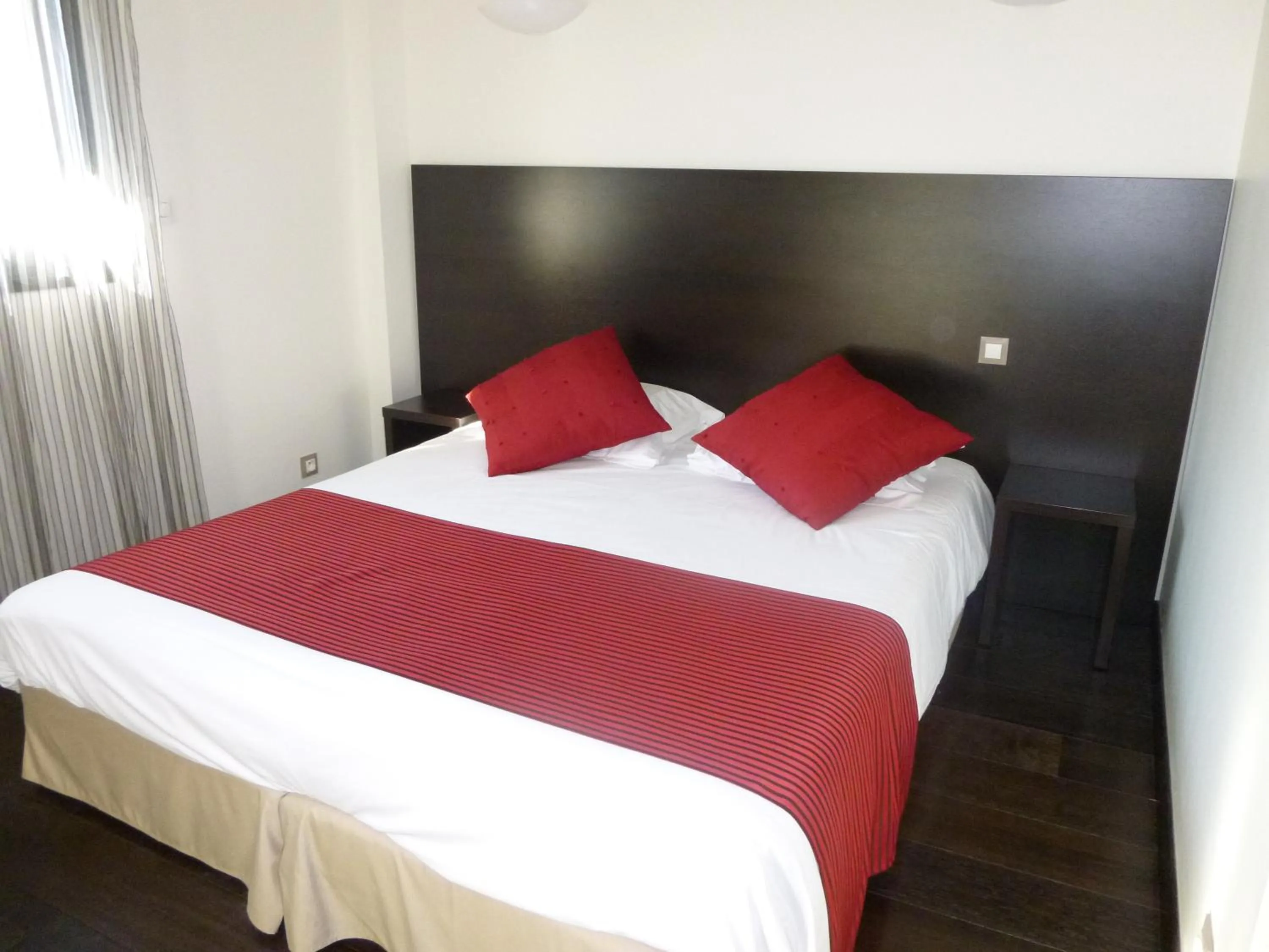 Bed in Logis Hôtel Terre de Loire