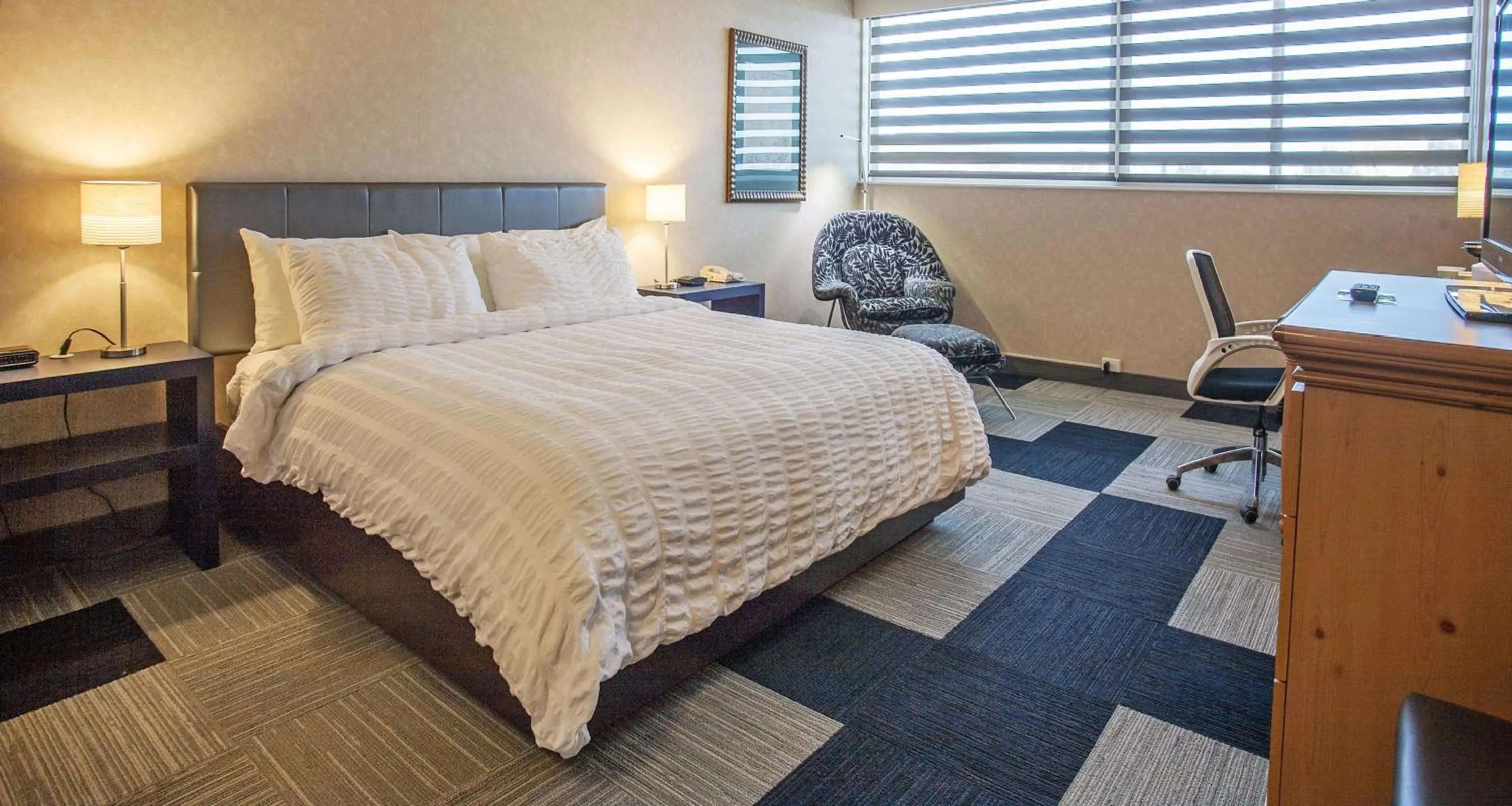 Photo of the whole room, Bed in The Rushmore Hotel & Suites; BW Premier Collection