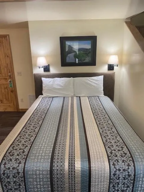 Bed in Yellowstone Riverside Cottages