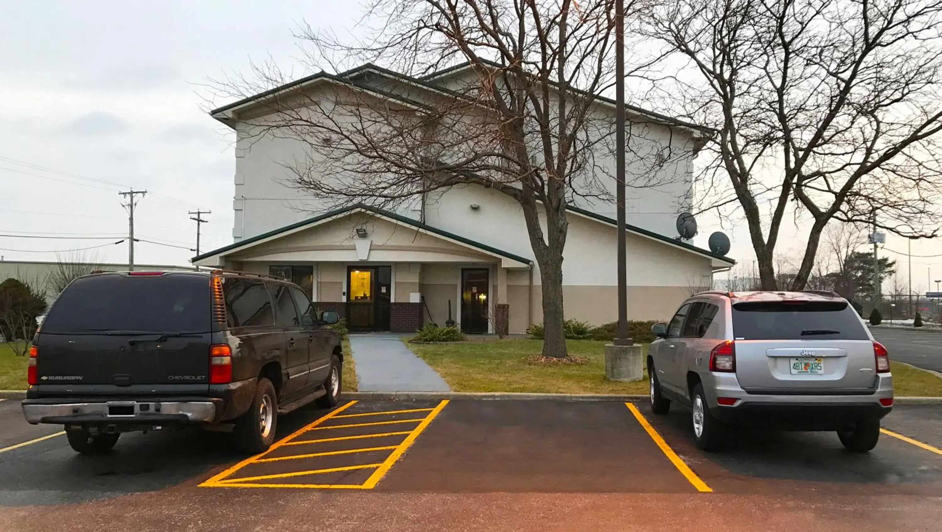 Parking, Property Building in Magnuson Hotel Fort Wayne North - Coliseum