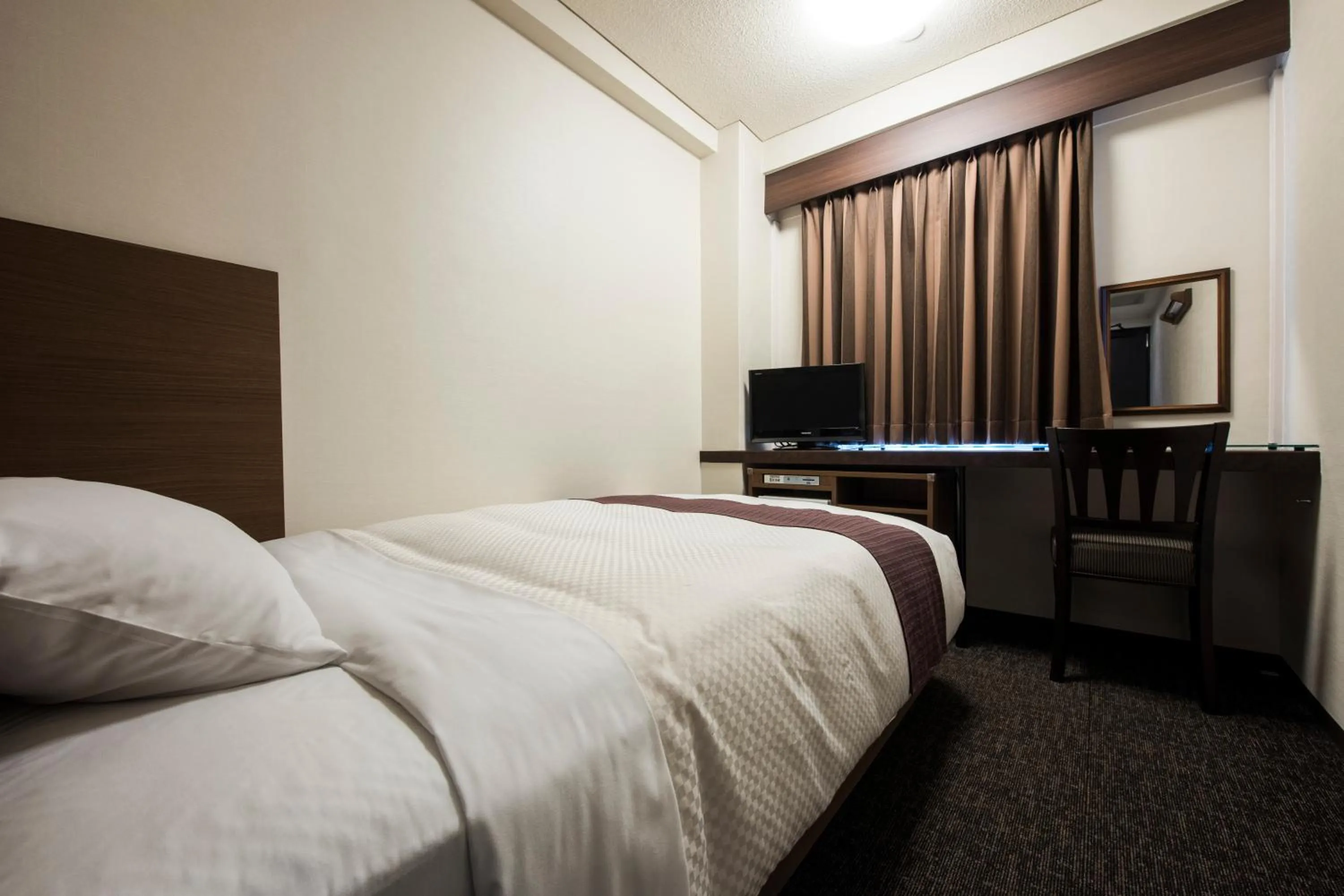 Photo of the whole room, Bed in Nagasaki Bus Terminal Hotel