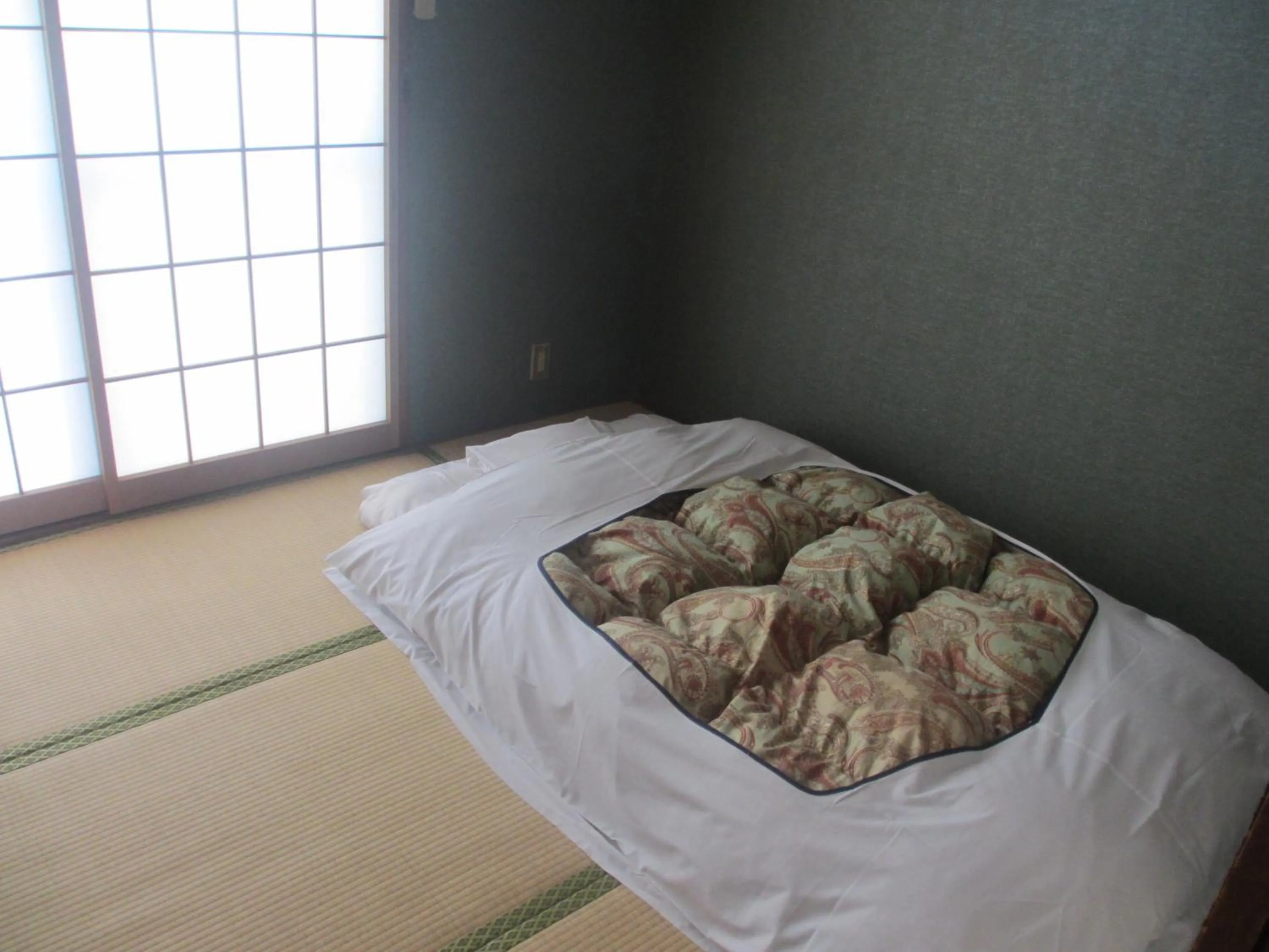 Bed in Hotel Sankyu