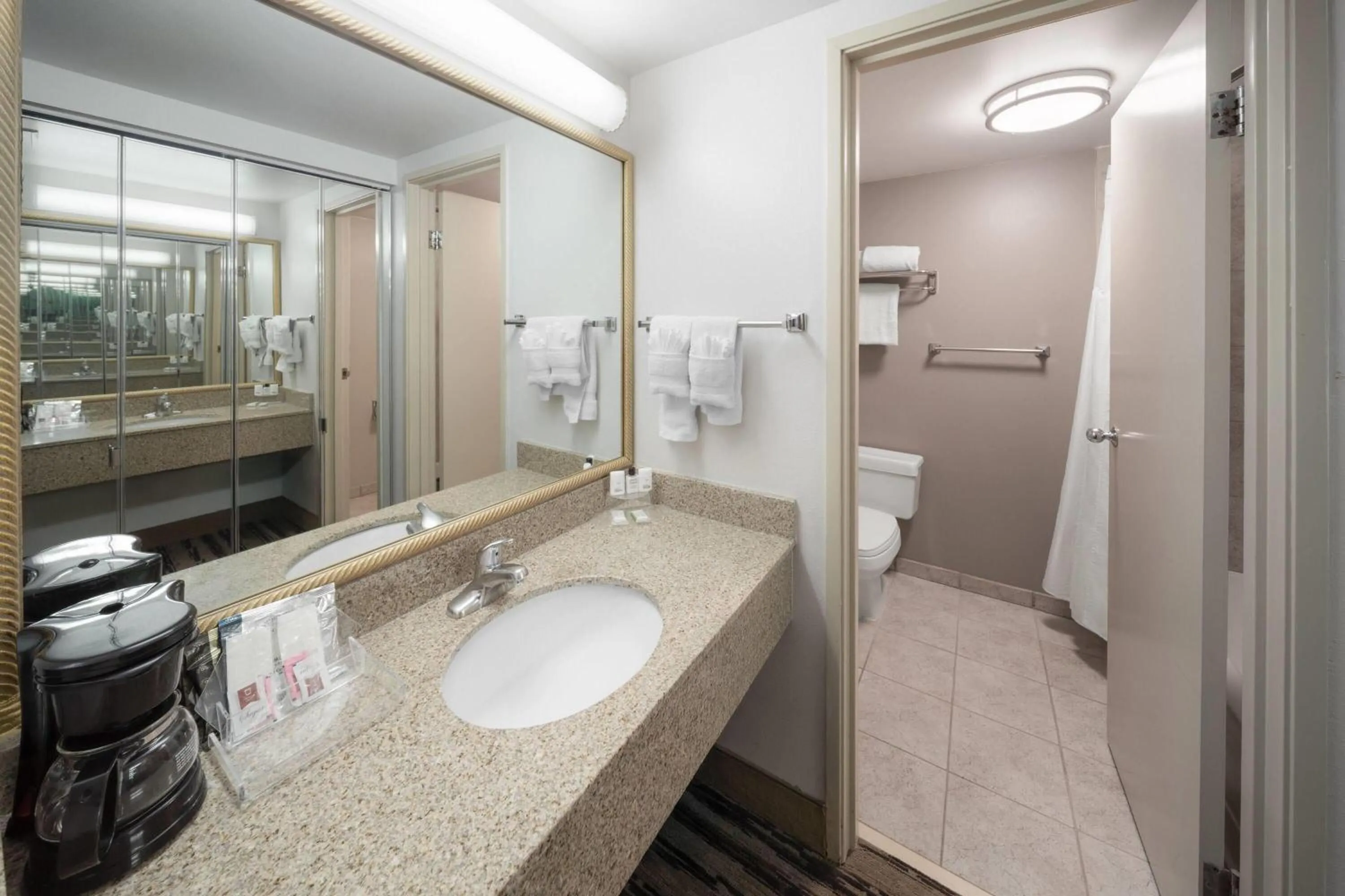 Bathroom in Endeavor Inn & Suites, Trademark Collection by Wyndham