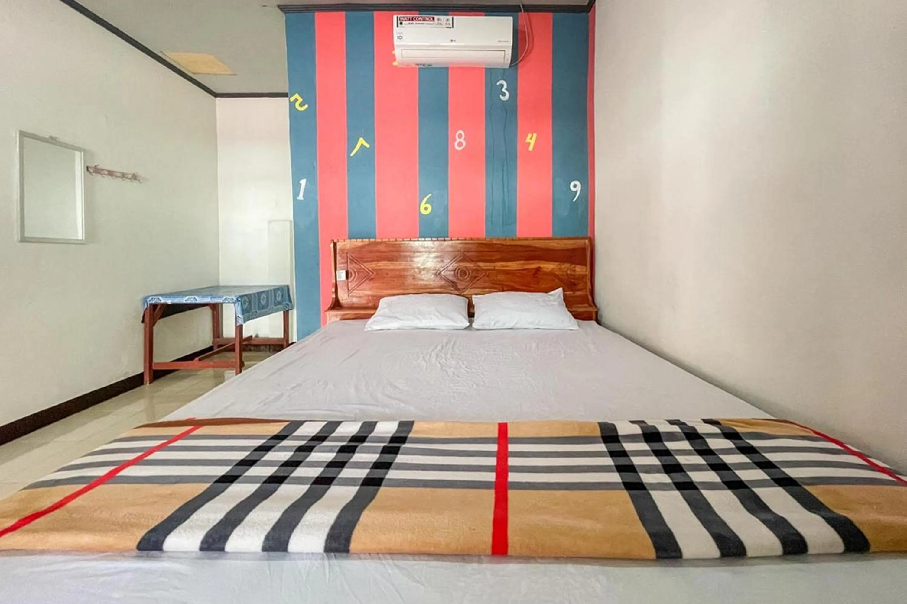 Bed in Ekas Beach Guesthouse Mitra RedDoorz