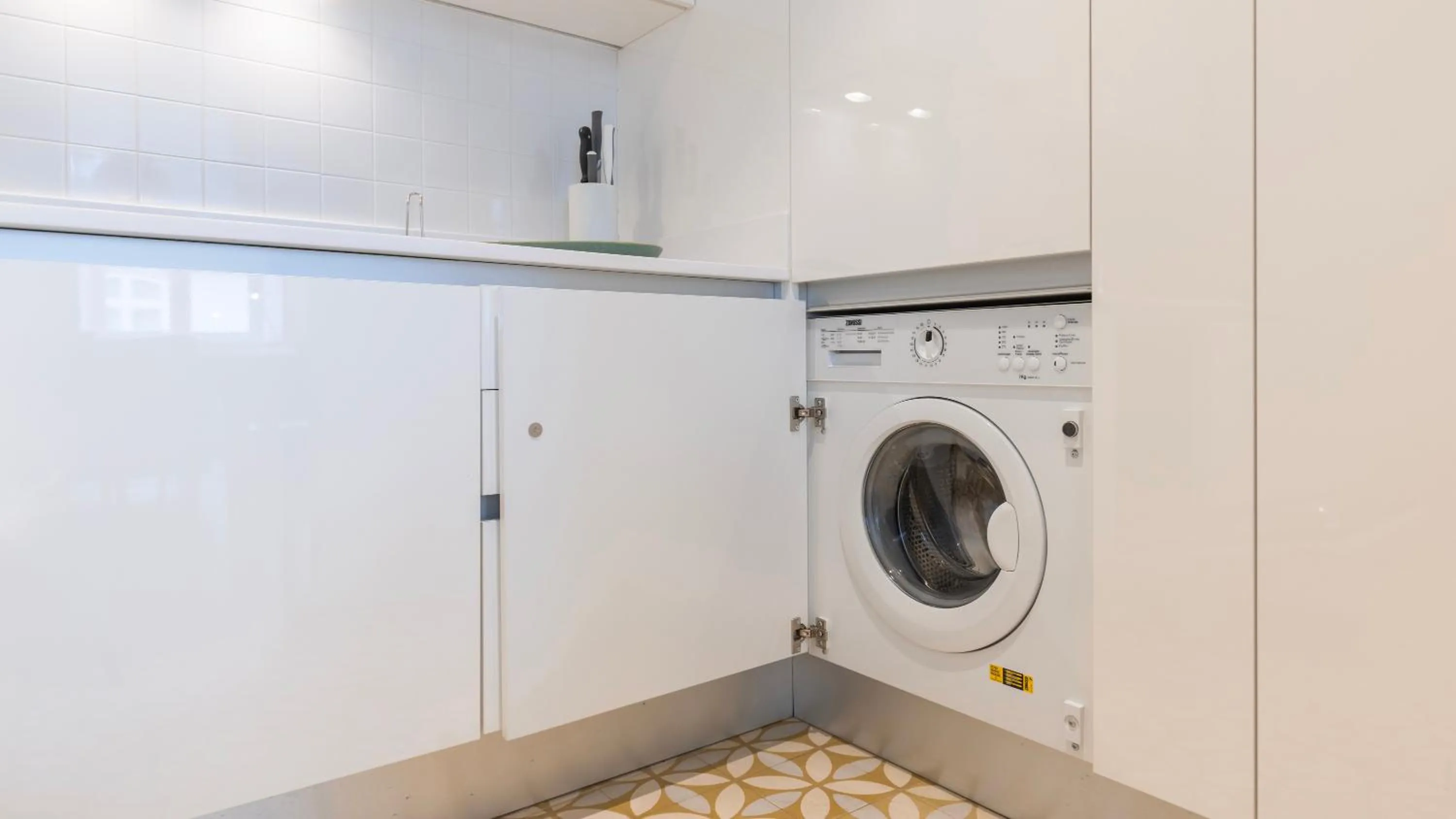 washing machine in Downtown by the River Apartment by LovelyStay