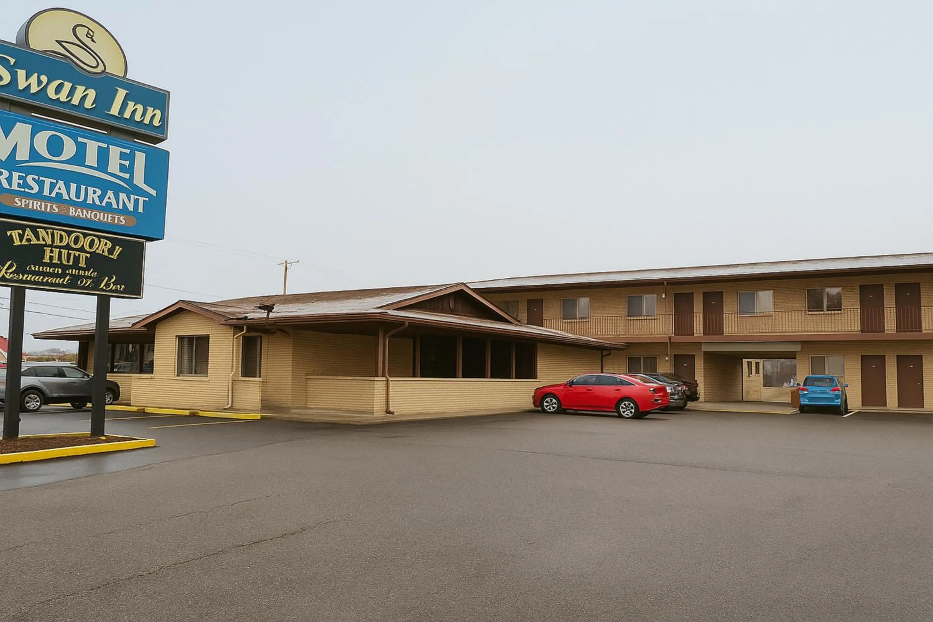 Property building in Capital O Swan Inn Comstock Park