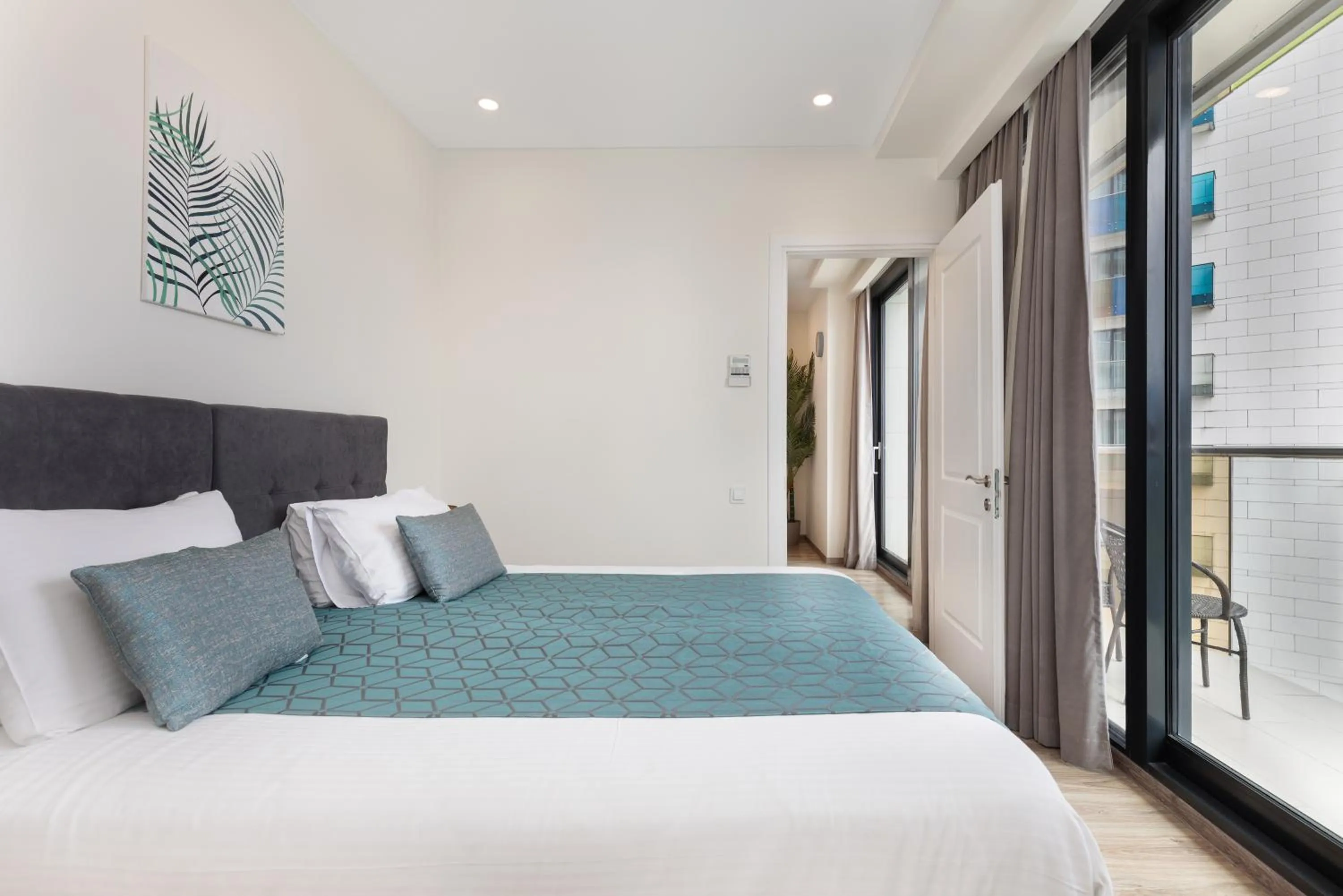 Bed in Bellevue Residence Suites