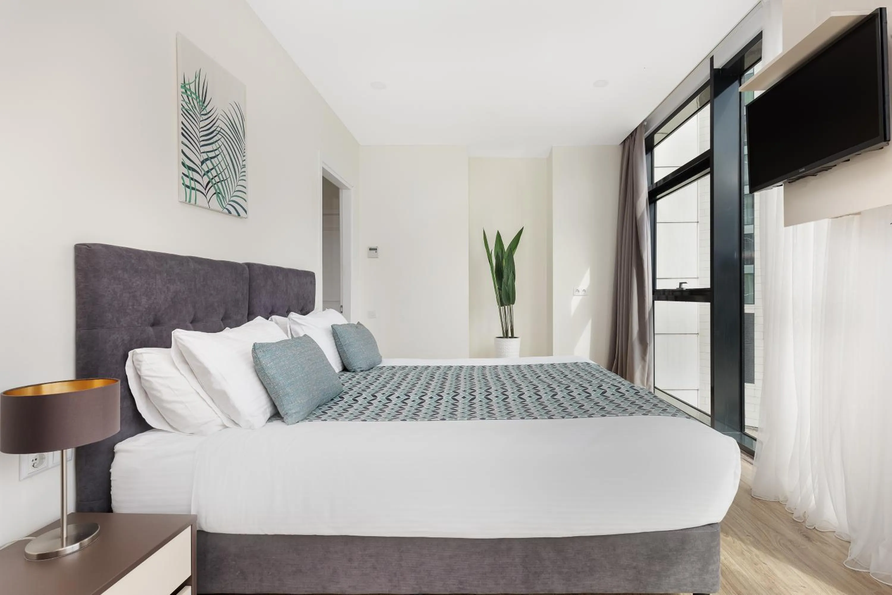 Bed in Bellevue Residence Suites