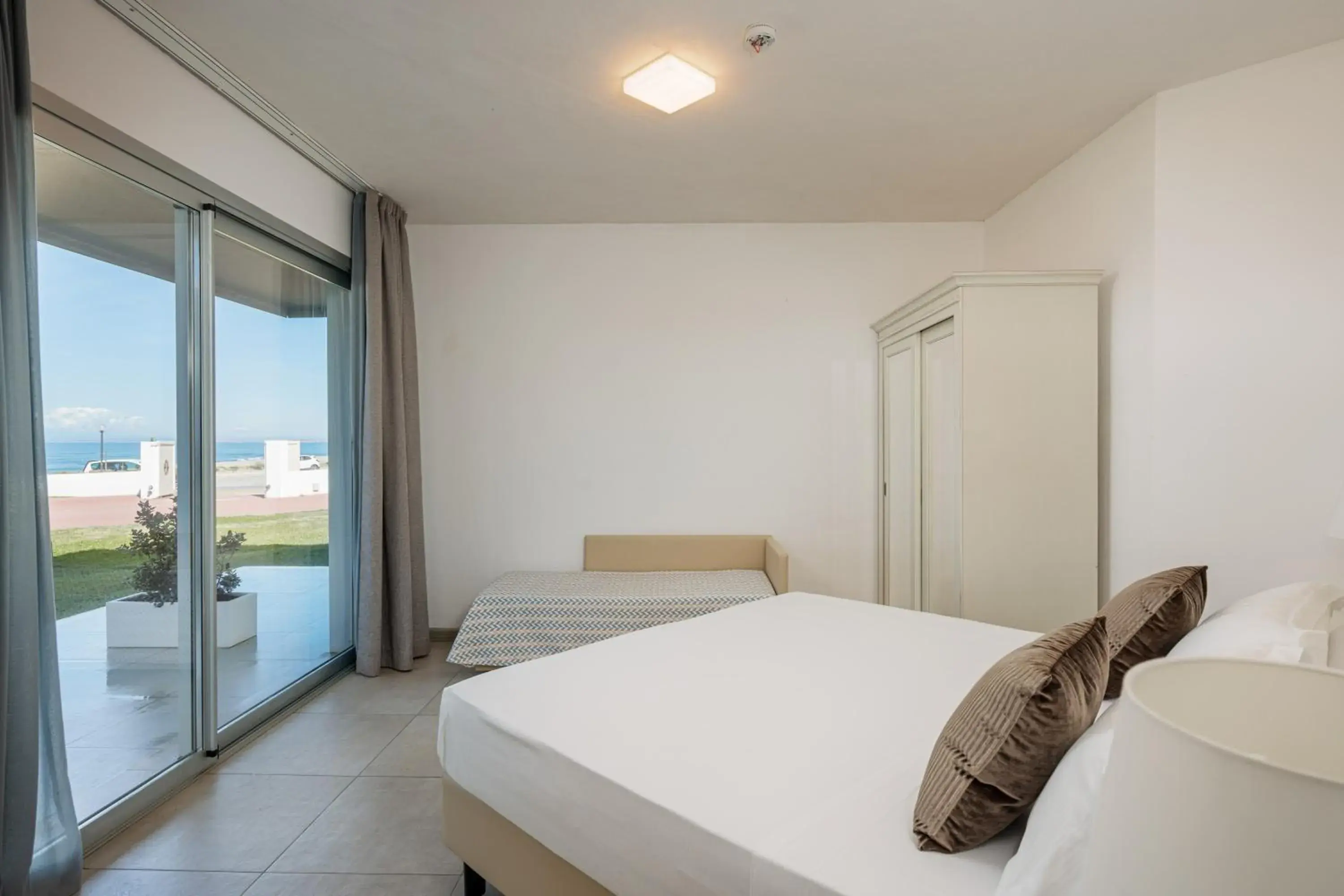 Bed in Bellevue Sardinia Resort Affiliated by Meliá Bed in Bellevue Sardinia Resort Affiliated by Meliá