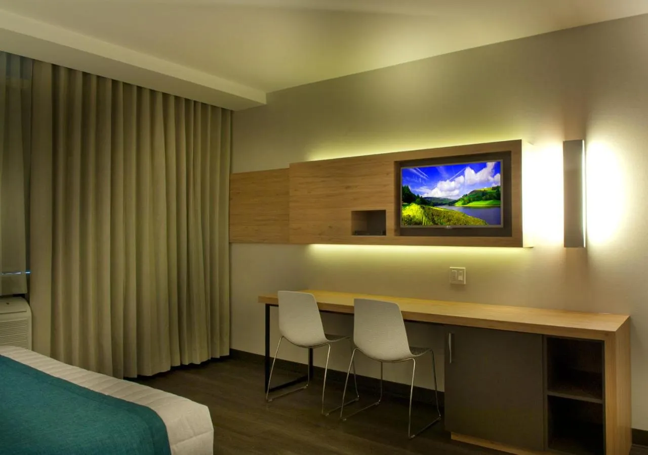 Dining area, Bed in Ramada by Wyndham Laval