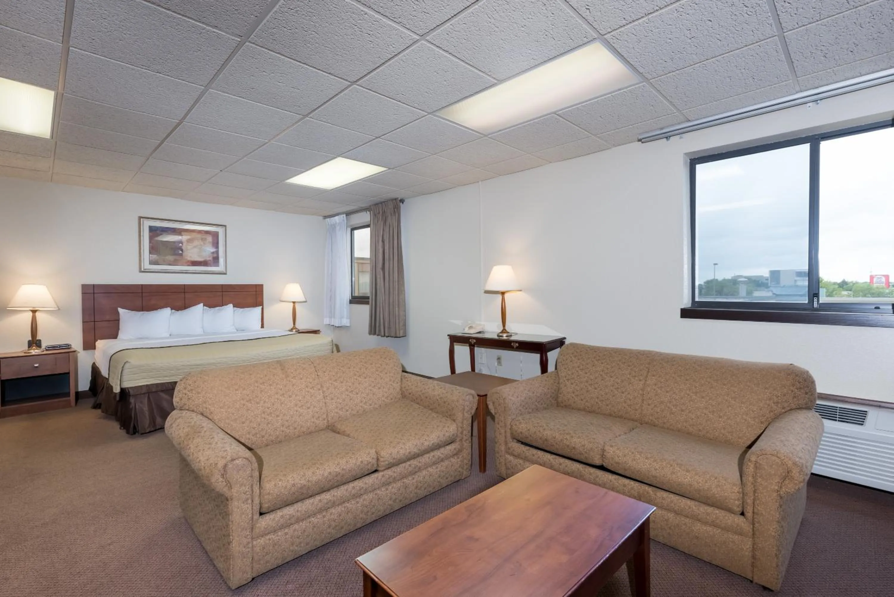 Living room, Bed in Ramada by Wyndham Fargo