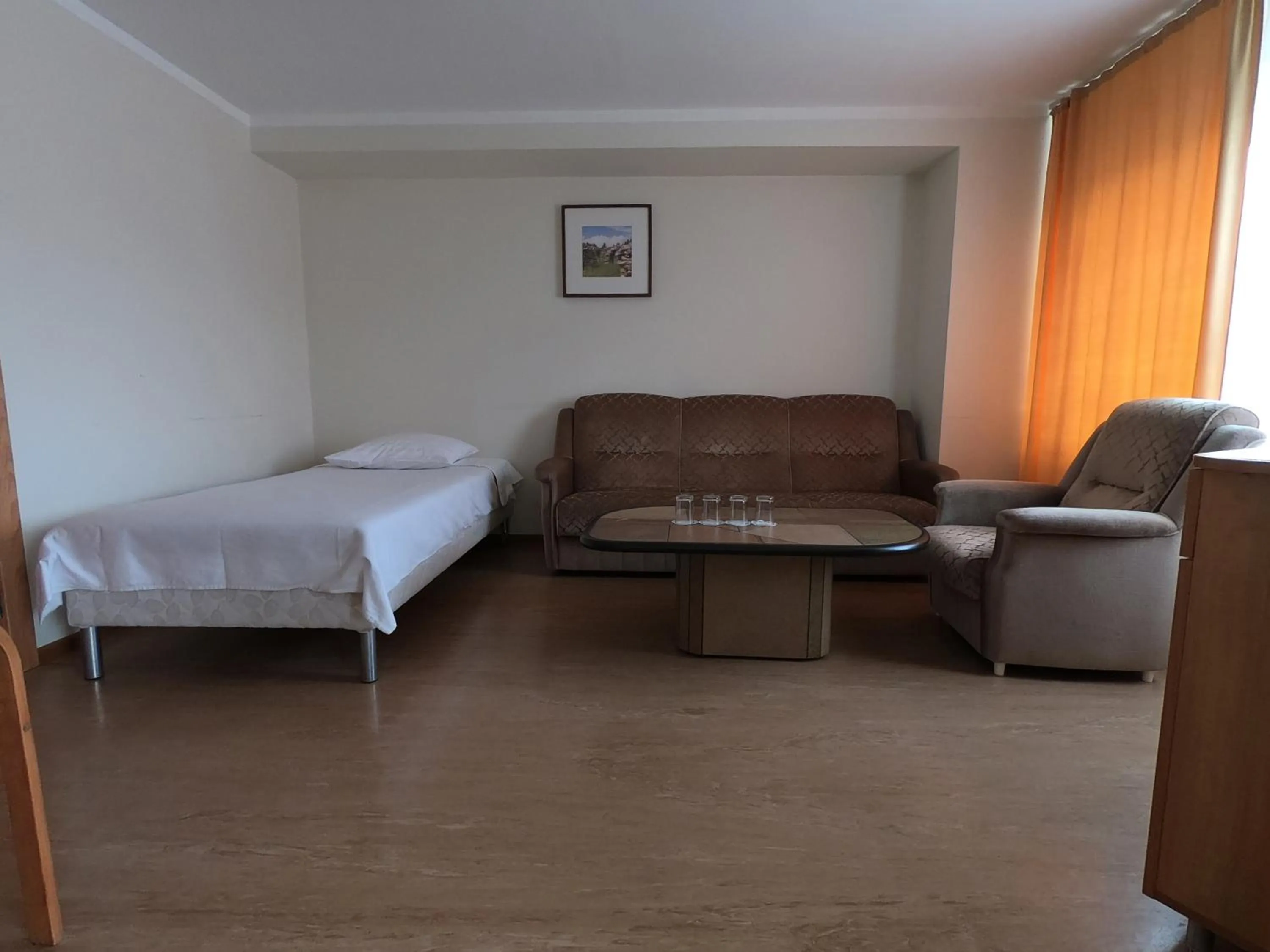 Seating area, Bed in Hotel Madona