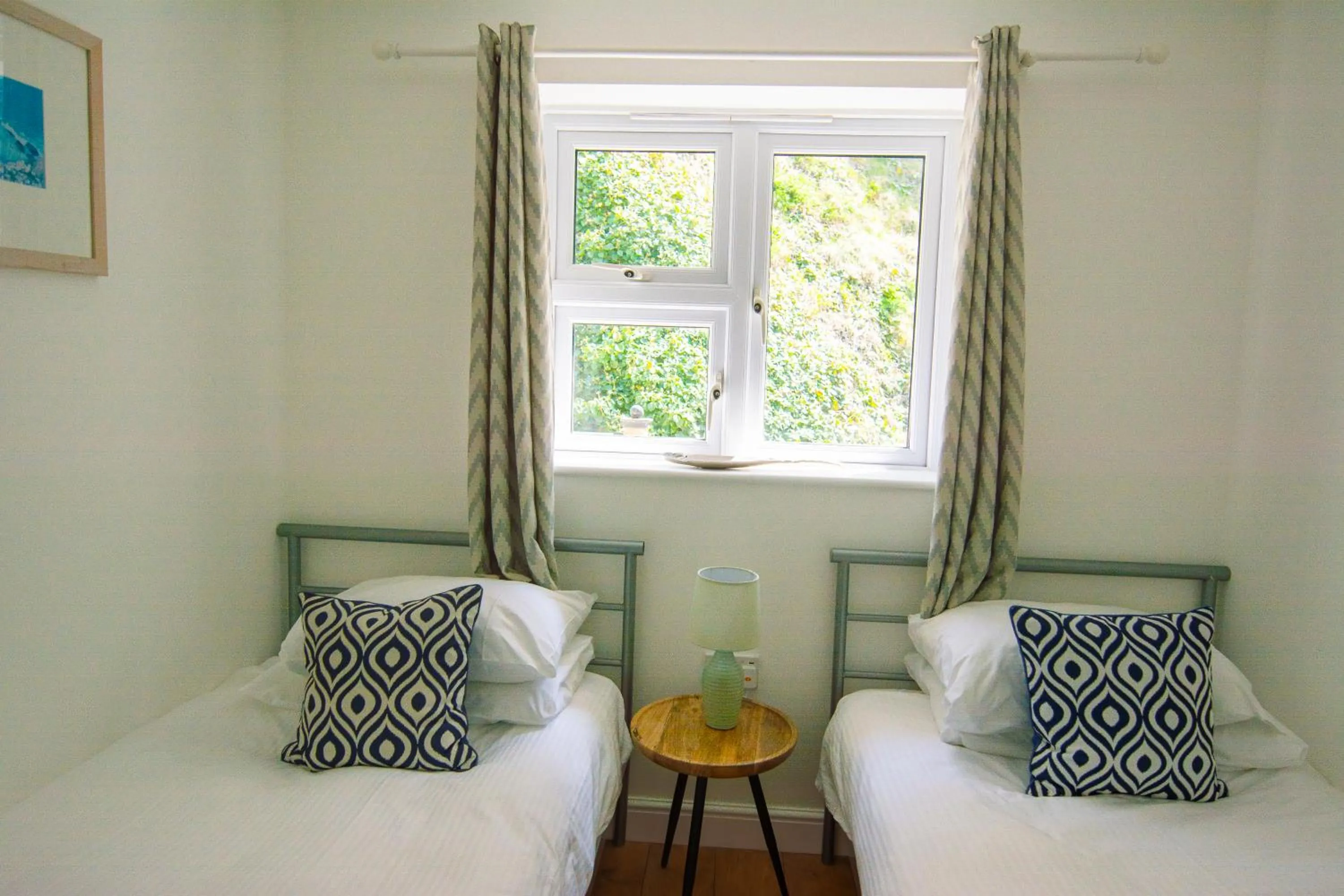 Bed in Tolcarne Beach Apartments