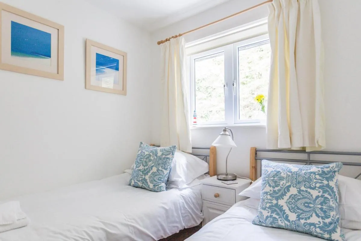 Bed in Tolcarne Beach Apartments