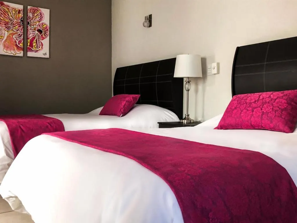 Bed in Hotel Bugambilias Rooms