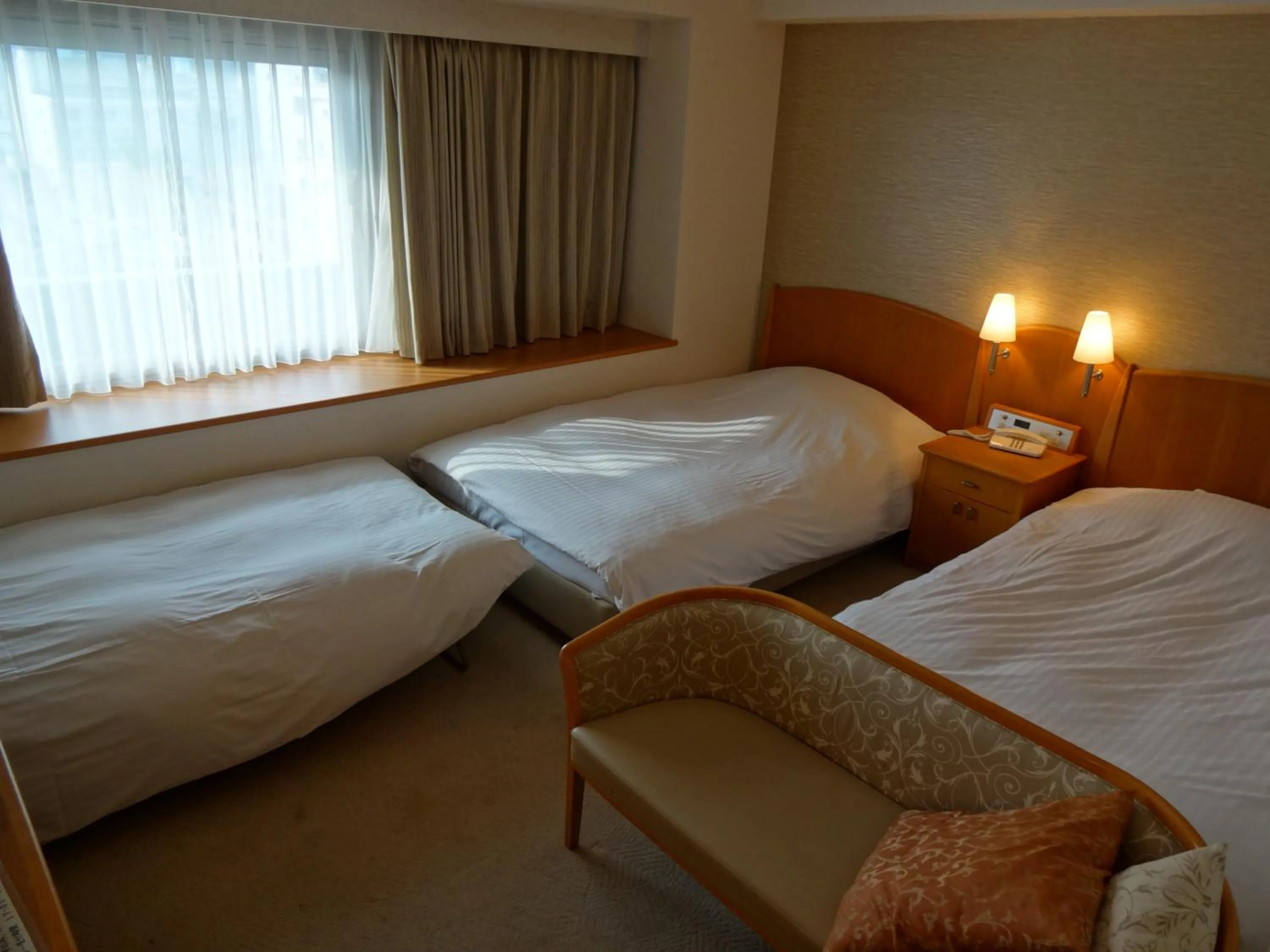 Bed in Kobe Luminous Hotel