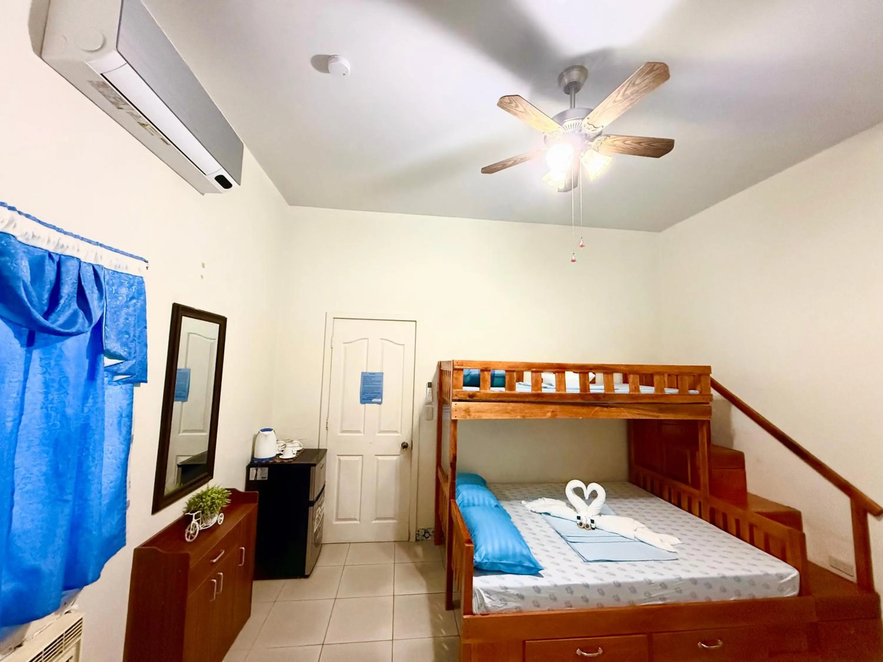 Bed in Blue Summer Suites & Restaurant