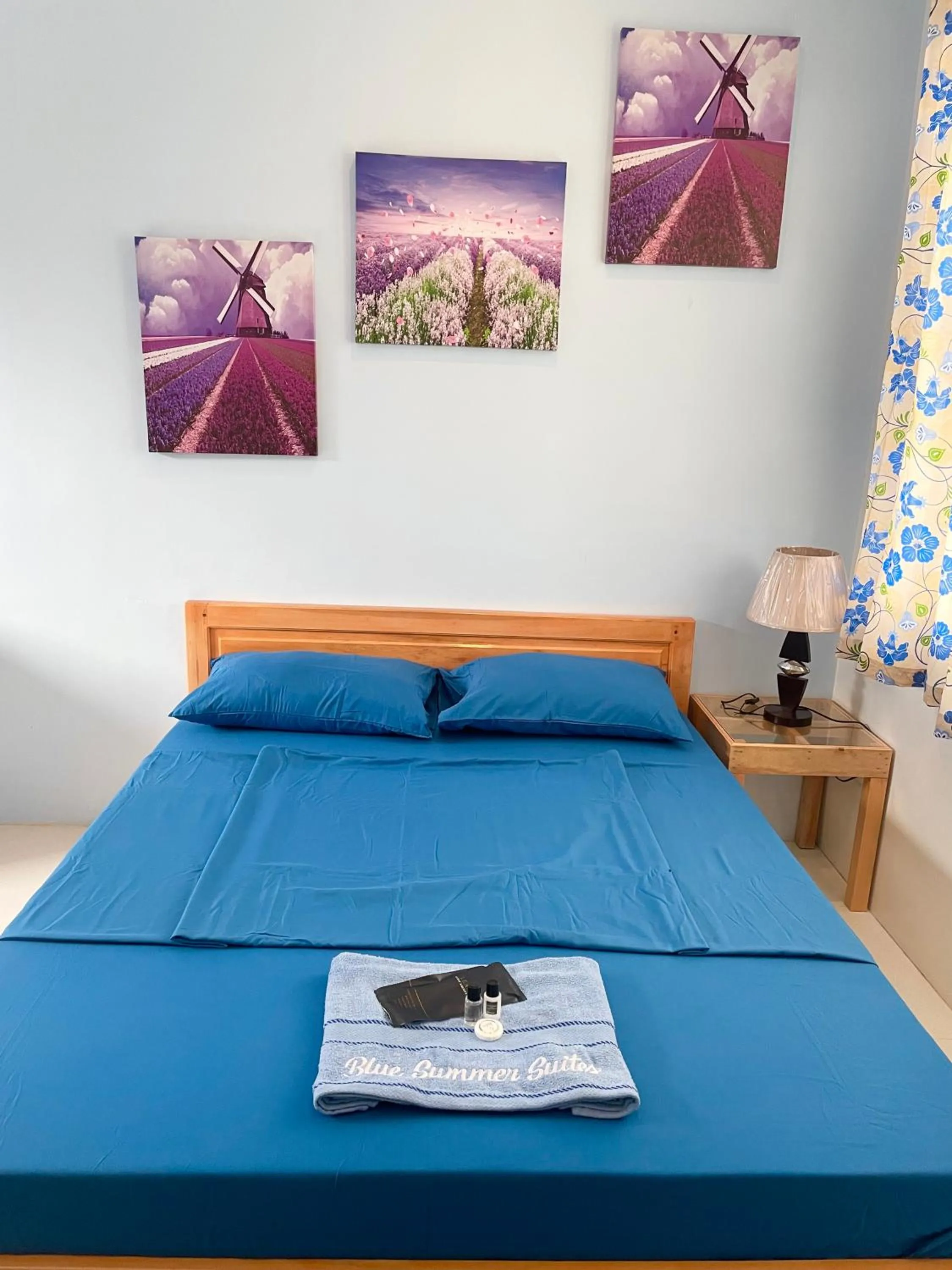 Bed in Blue Summer Suites & Restaurant