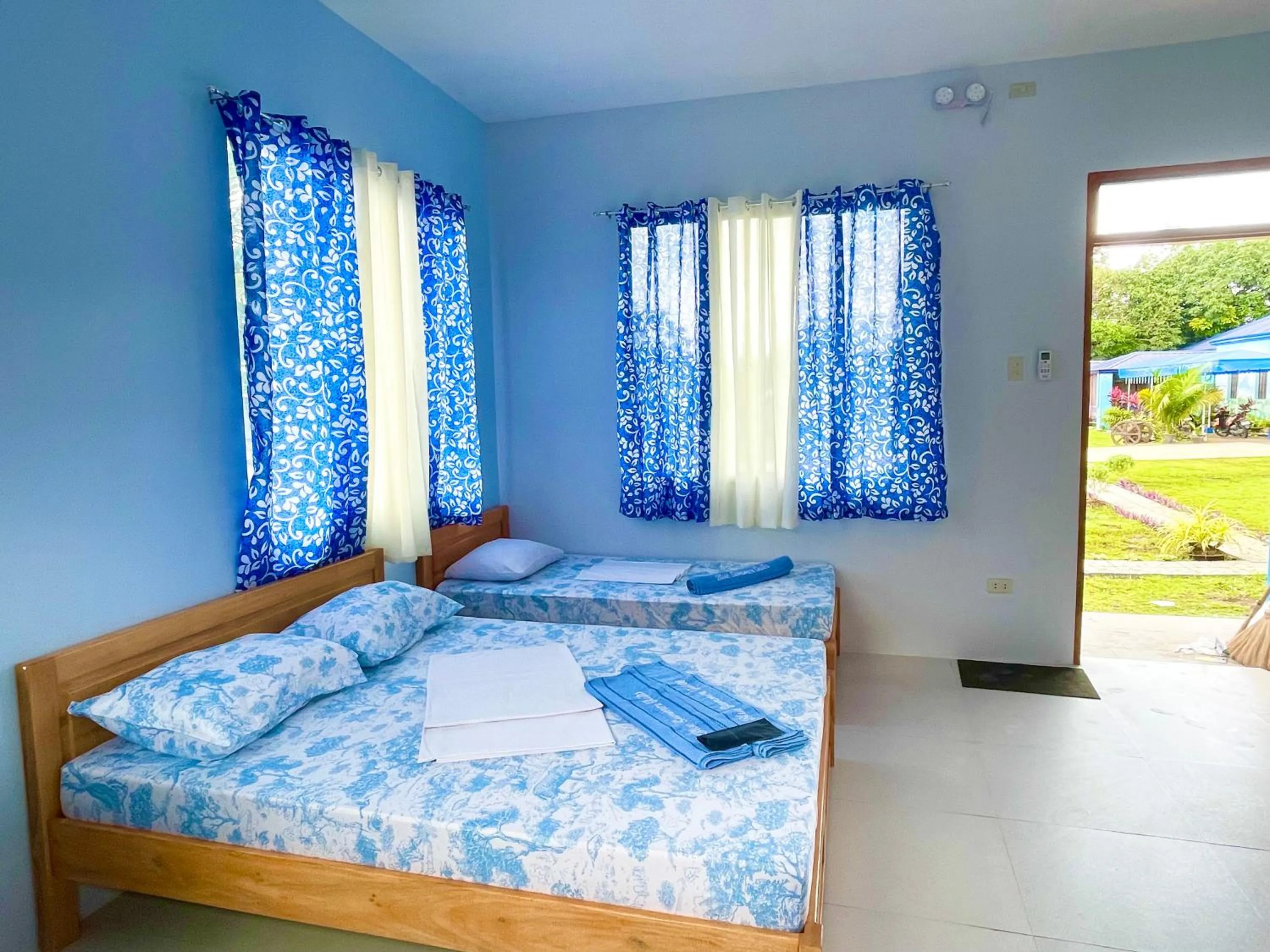 Bed in Blue Summer Suites & Restaurant