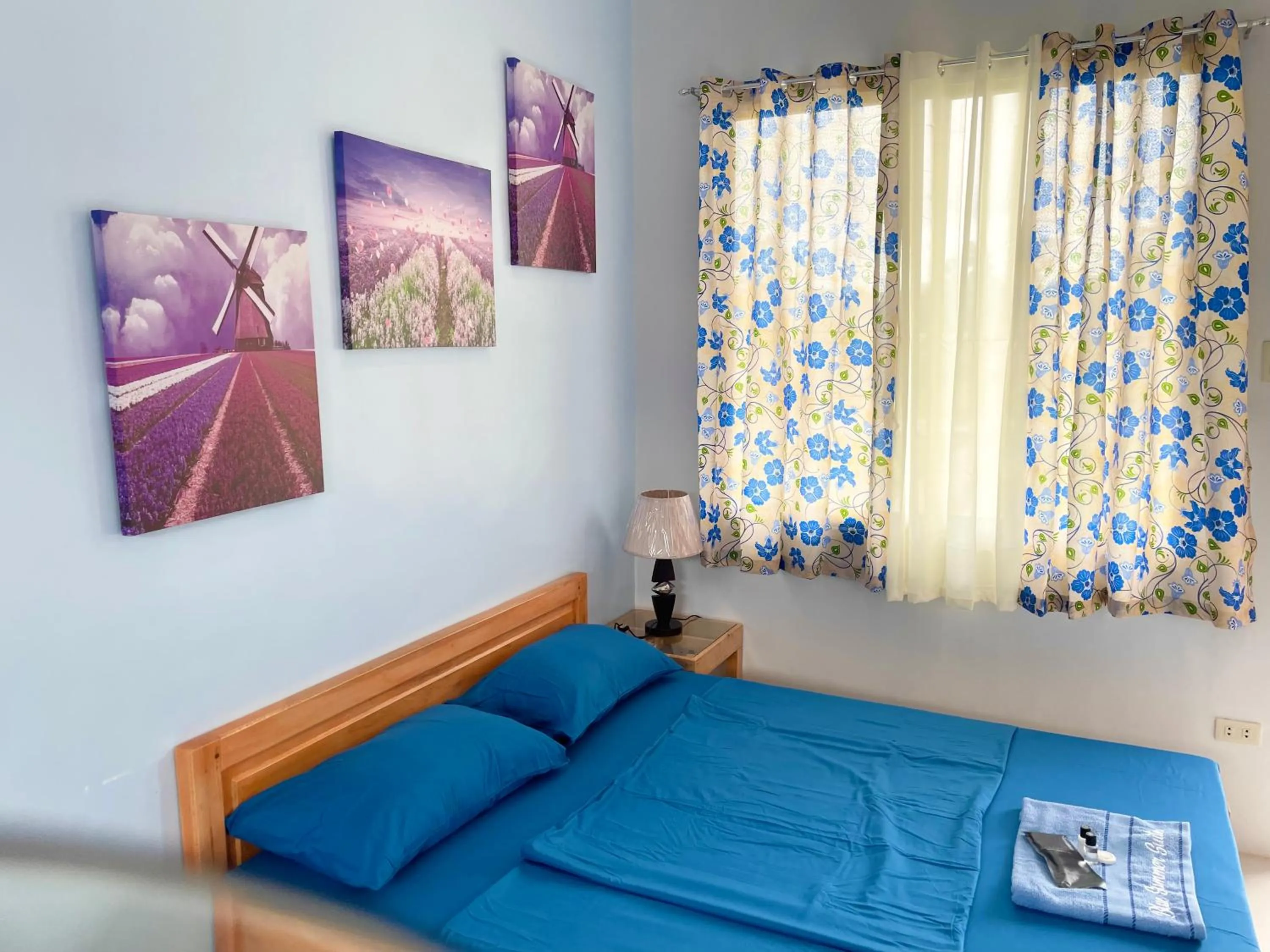 Bed in Blue Summer Suites & Restaurant