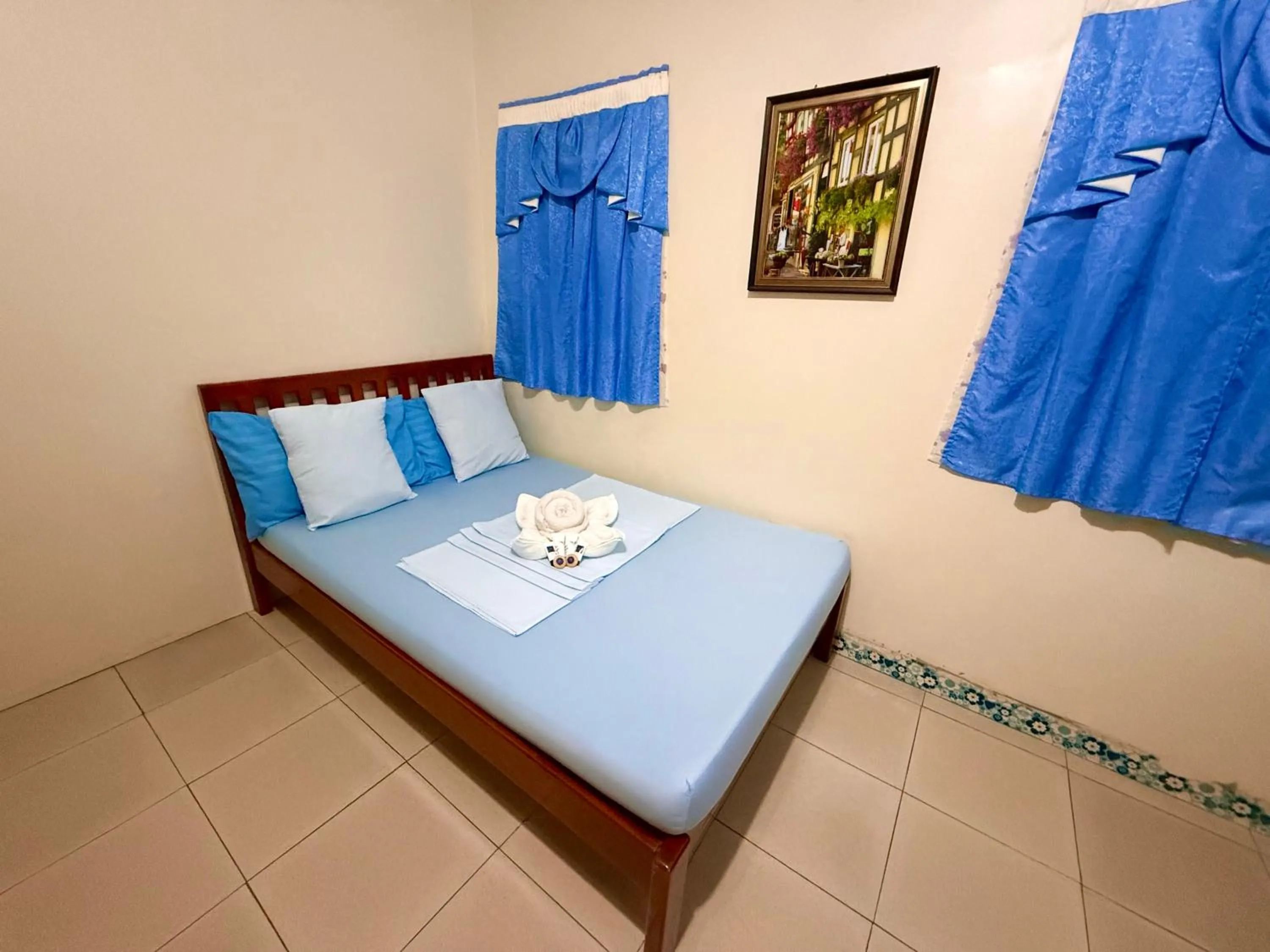 Bed in Blue Summer Suites & Restaurant