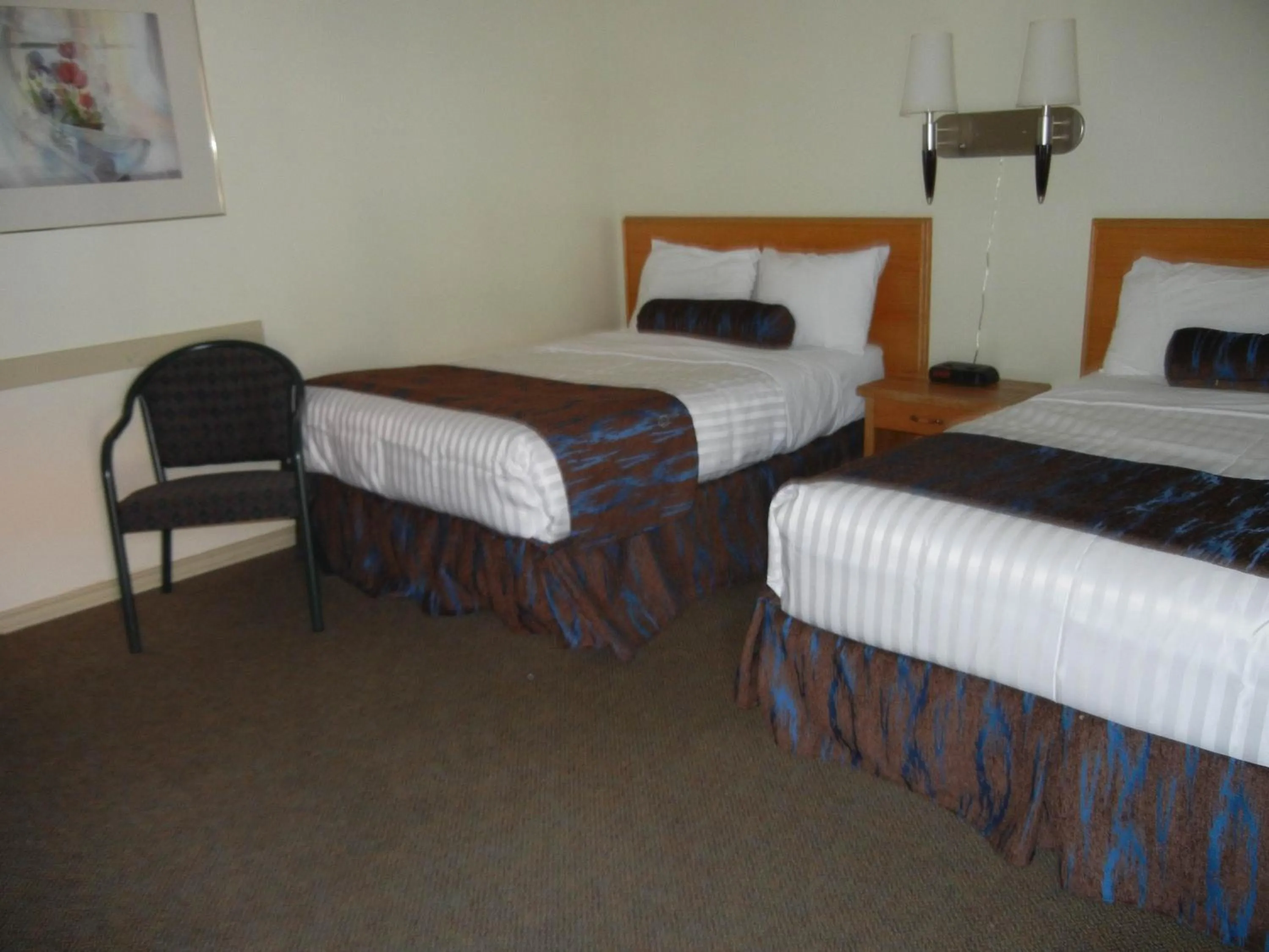 Bed in SlumberLodge Hotel