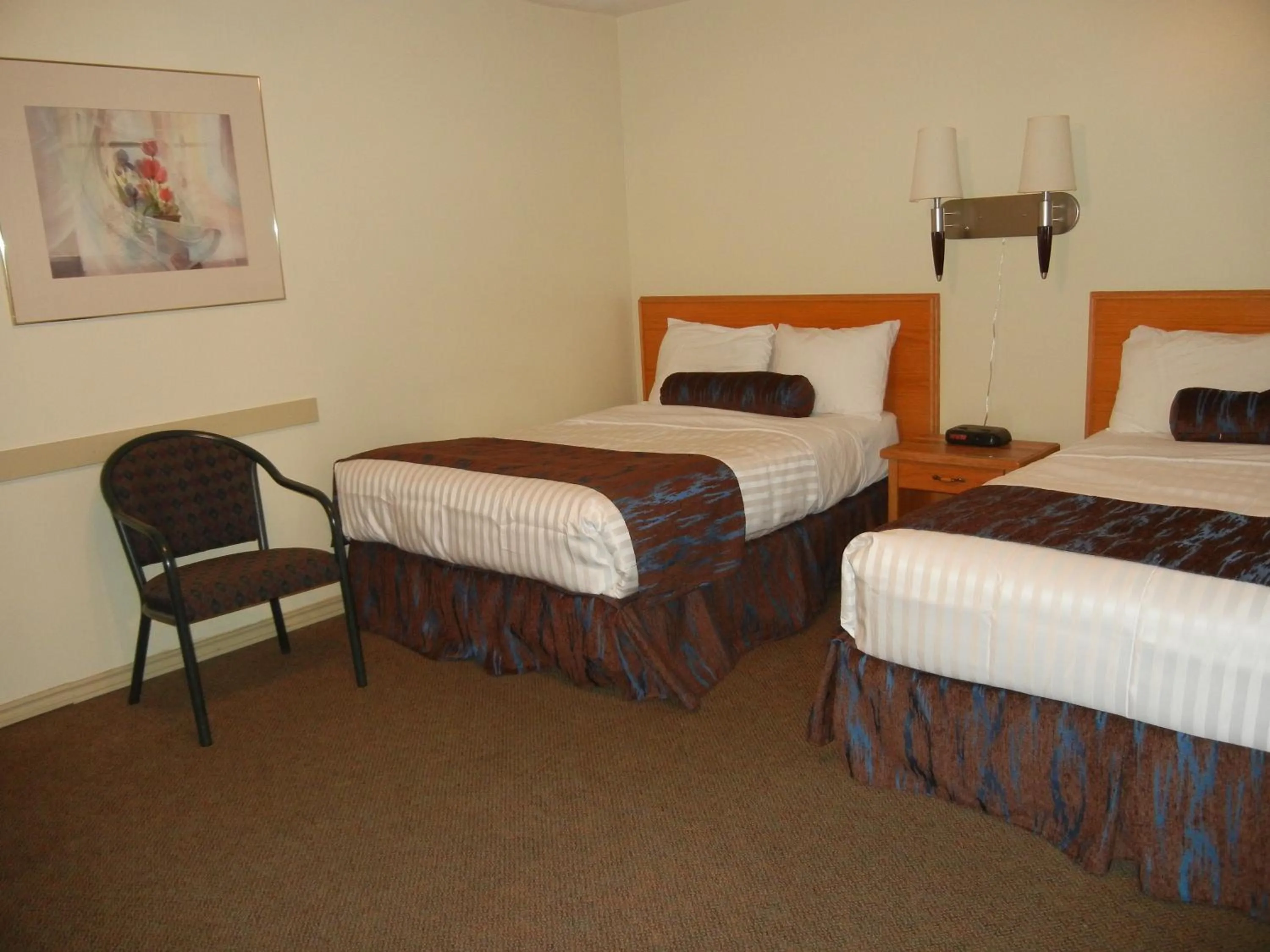 Bed in SlumberLodge Hotel