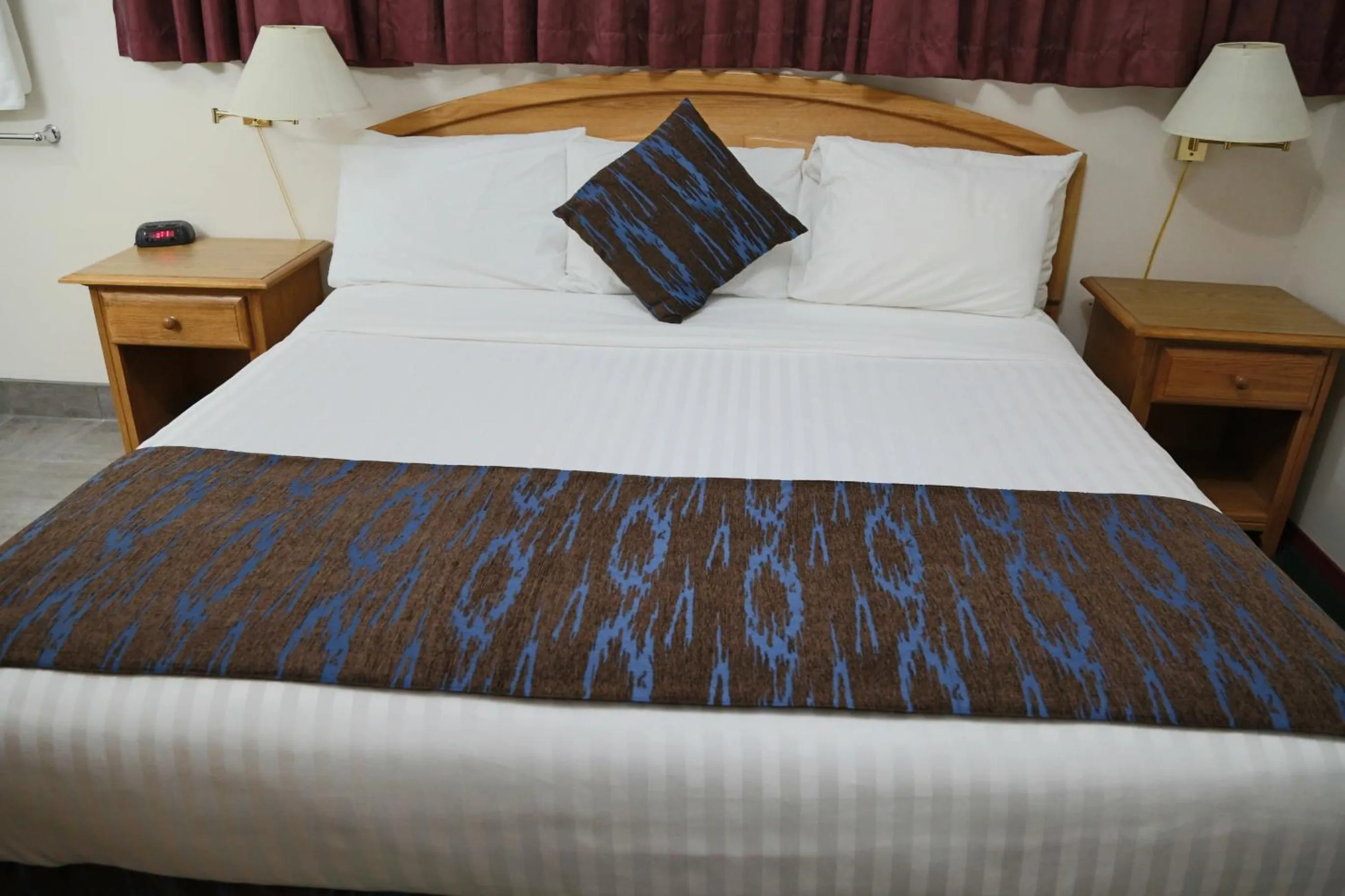 Bed in SlumberLodge Hotel
