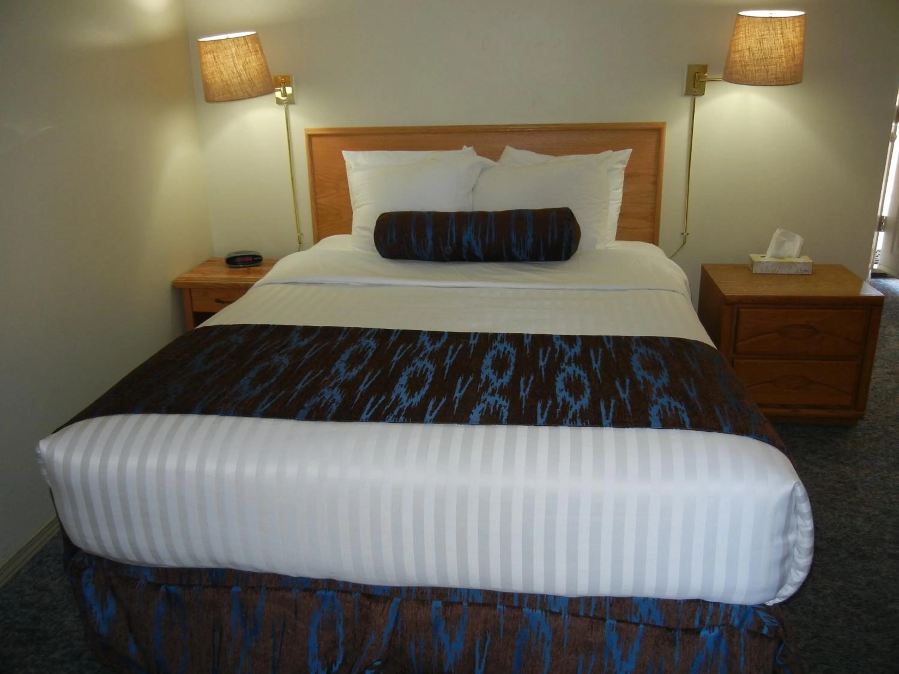 Bed in SlumberLodge Hotel