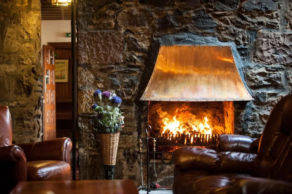 Communal lounge/ TV room in Loch Ness Lodge Hotel