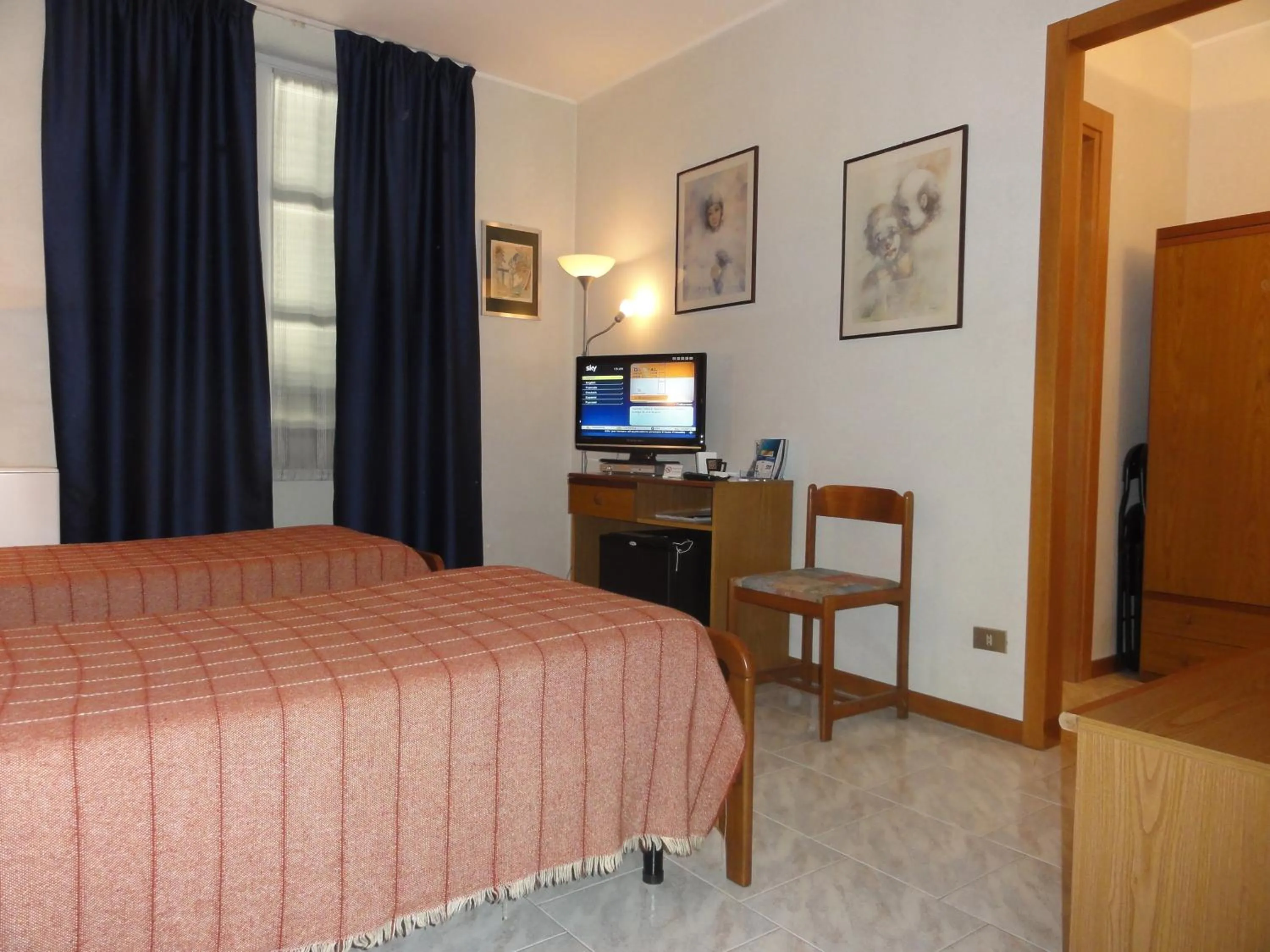 Communal lounge/ TV room, Bed in Albergo Ristorante Grigna