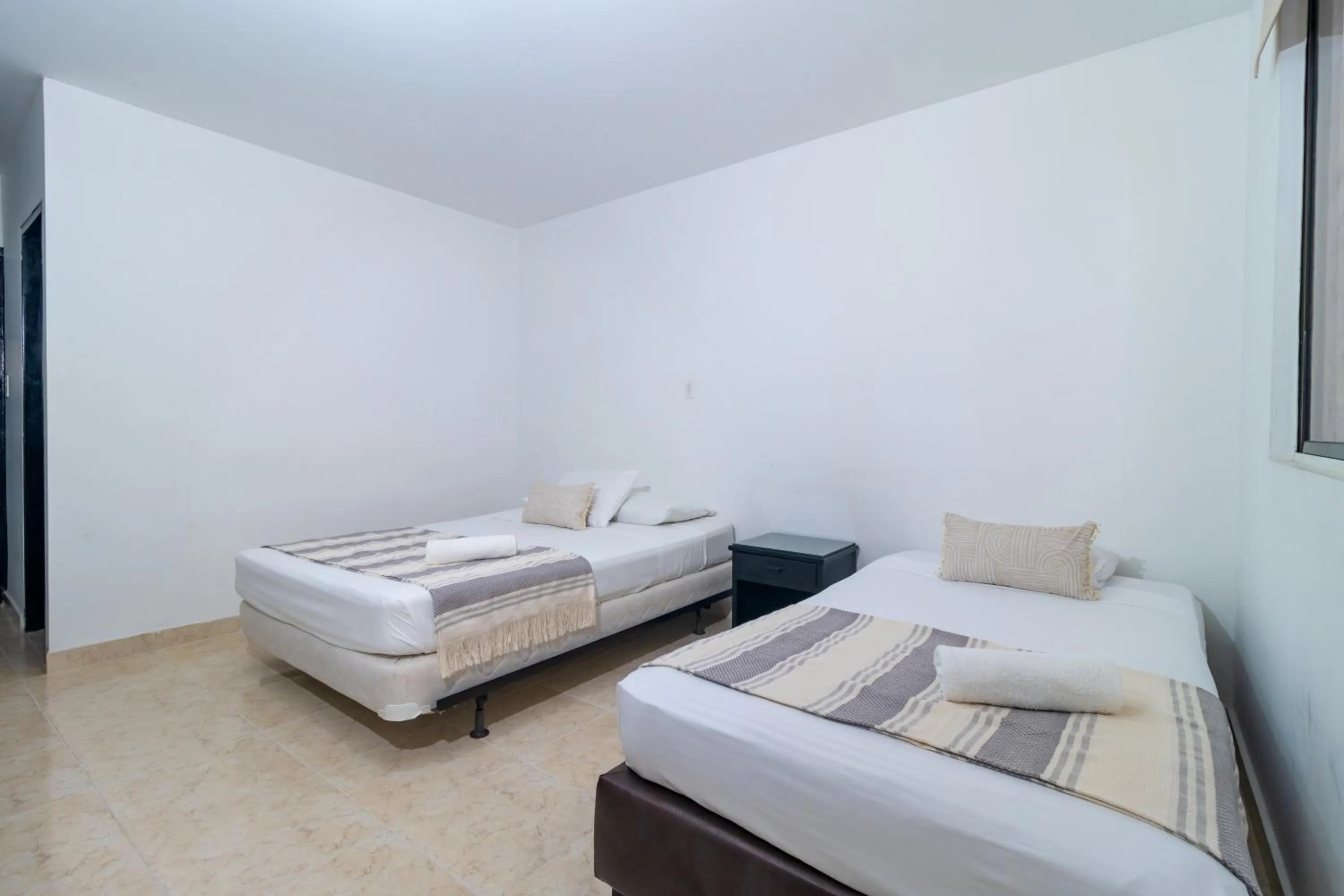 Bed in Hotel Axis Inn By GEH Suites