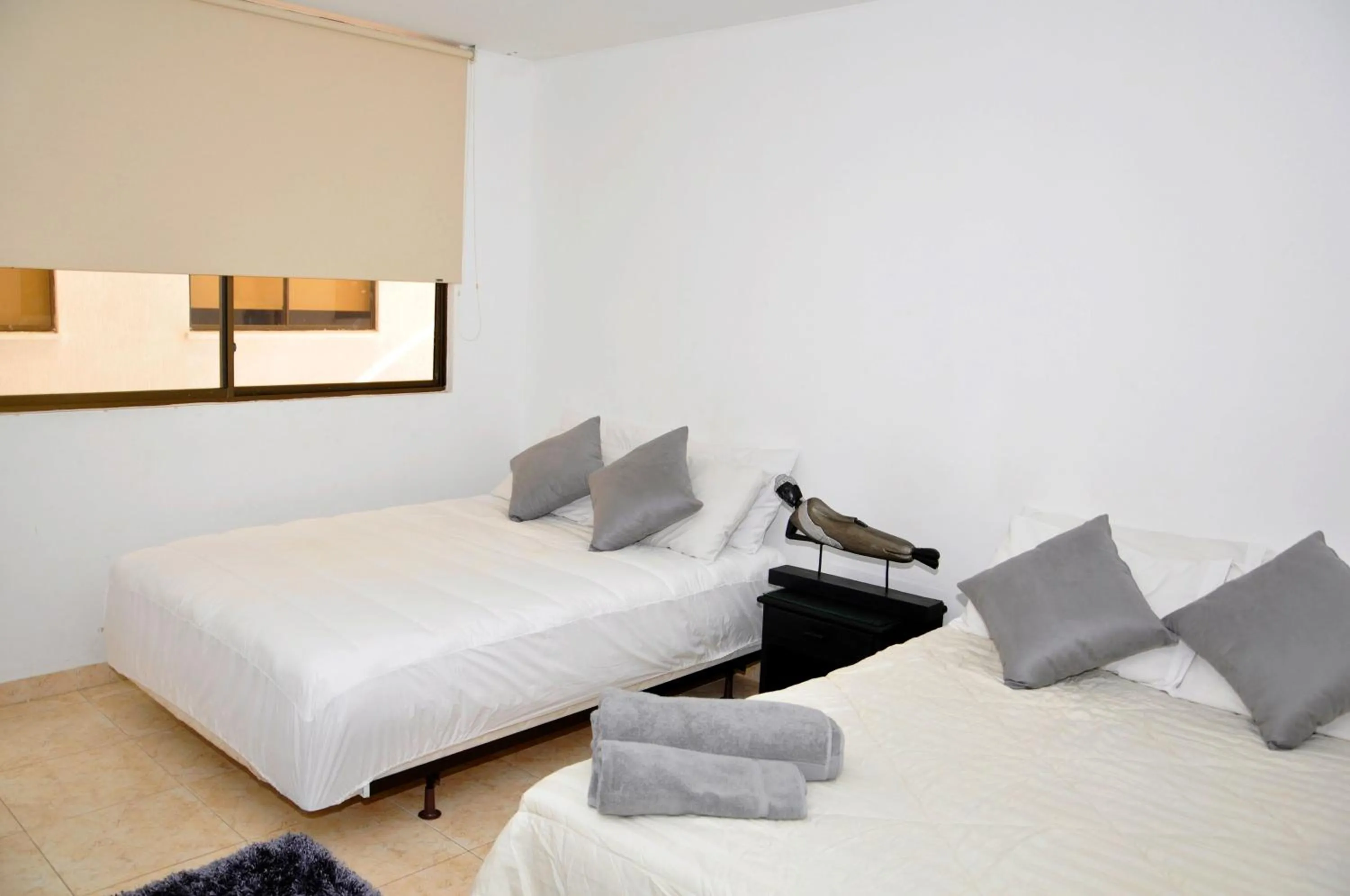 Bed in Hotel Axis Inn By GEH Suites