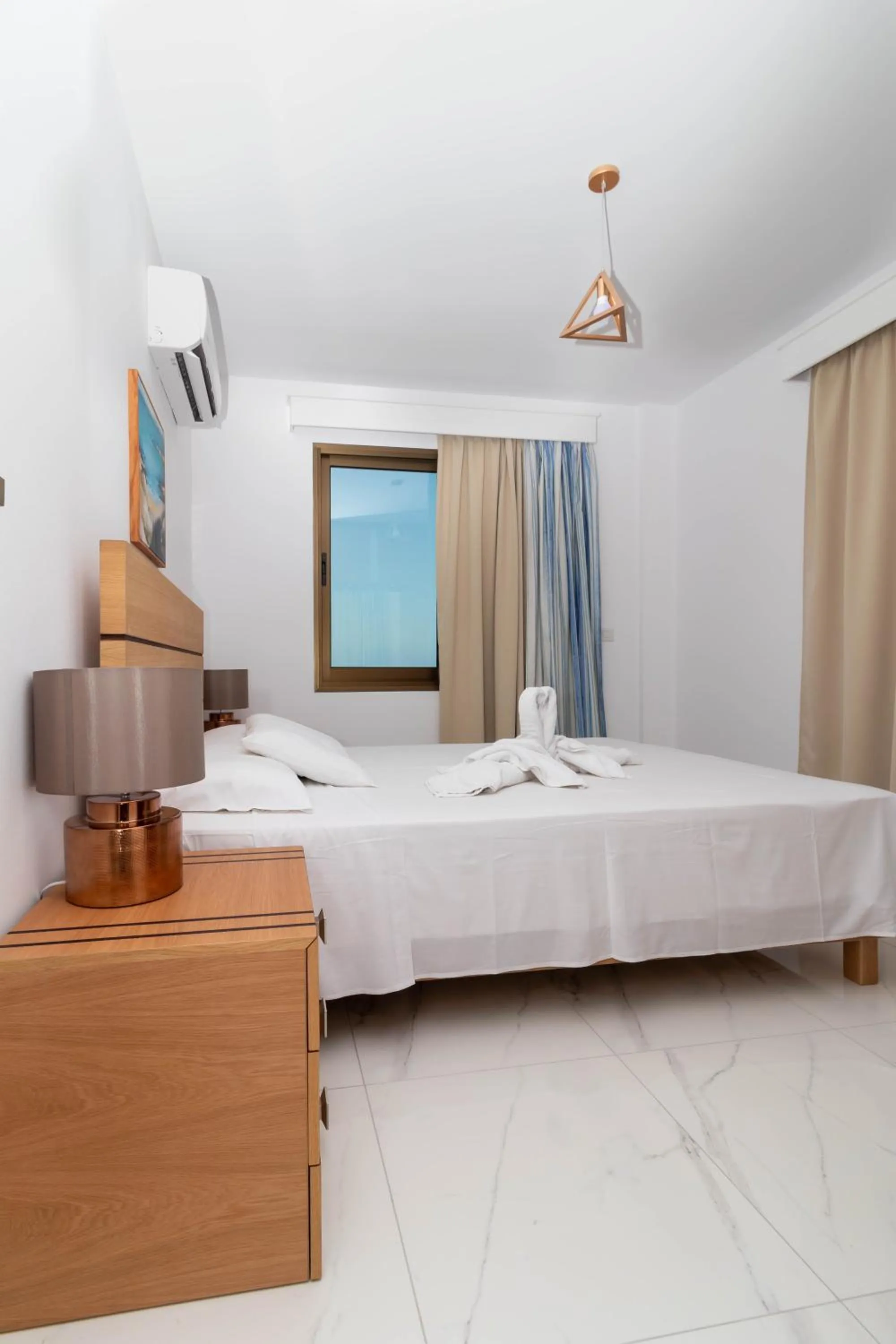 Bed in Rododafni Beach Apartments