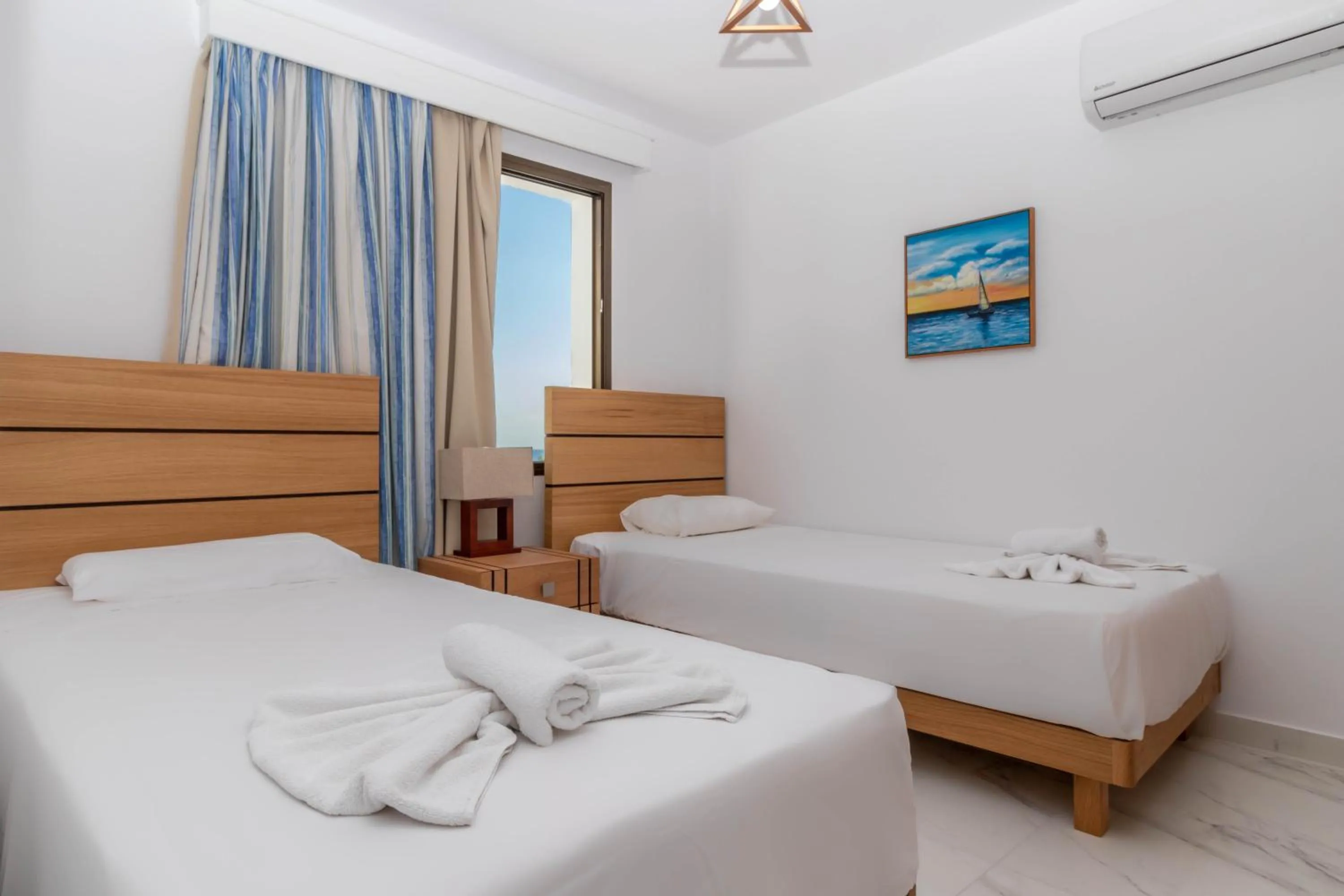 Bed in Rododafni Beach Apartments