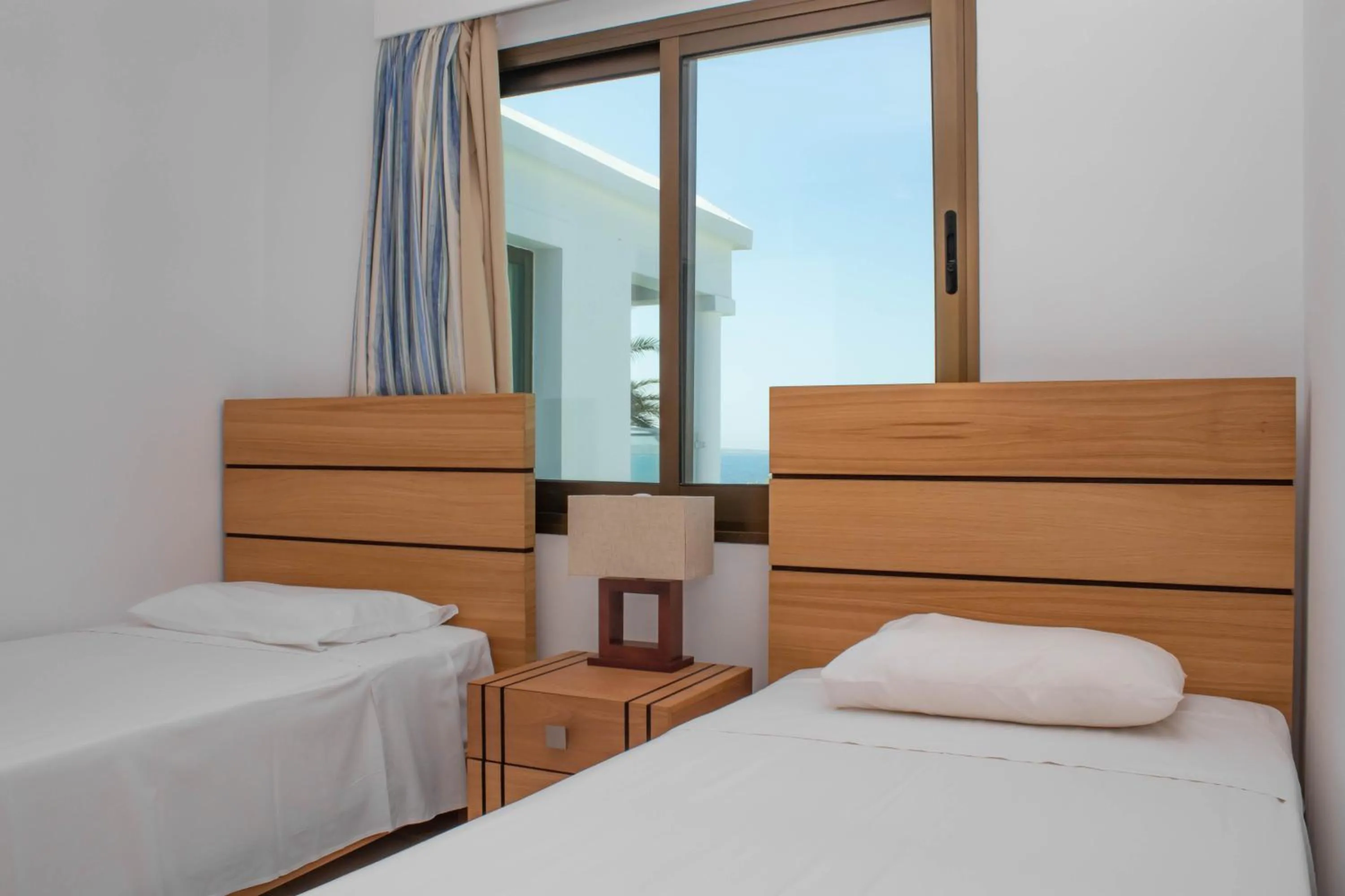 Bed in Rododafni Beach Apartments