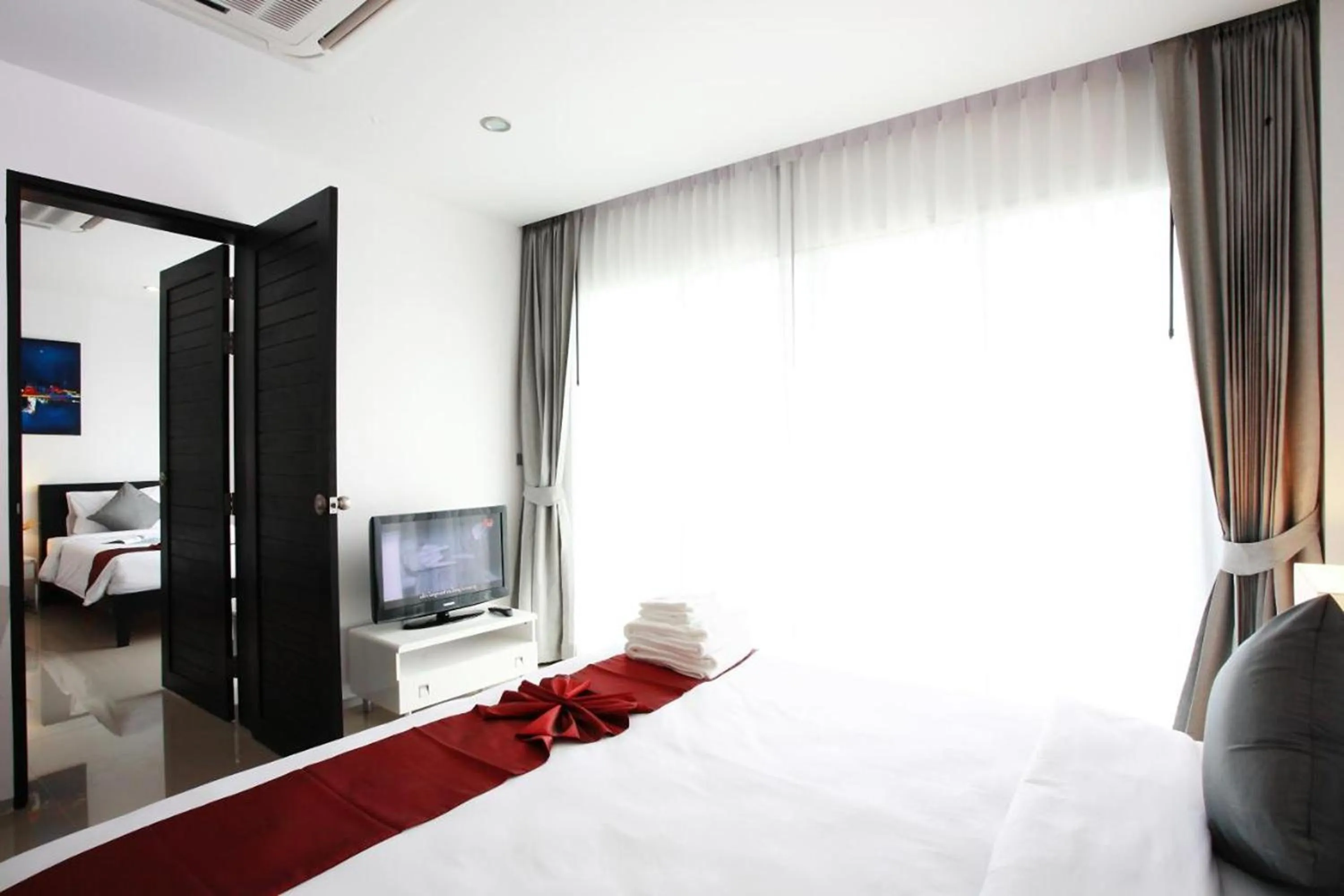 Bed in One World One Home Naiharn Hotel